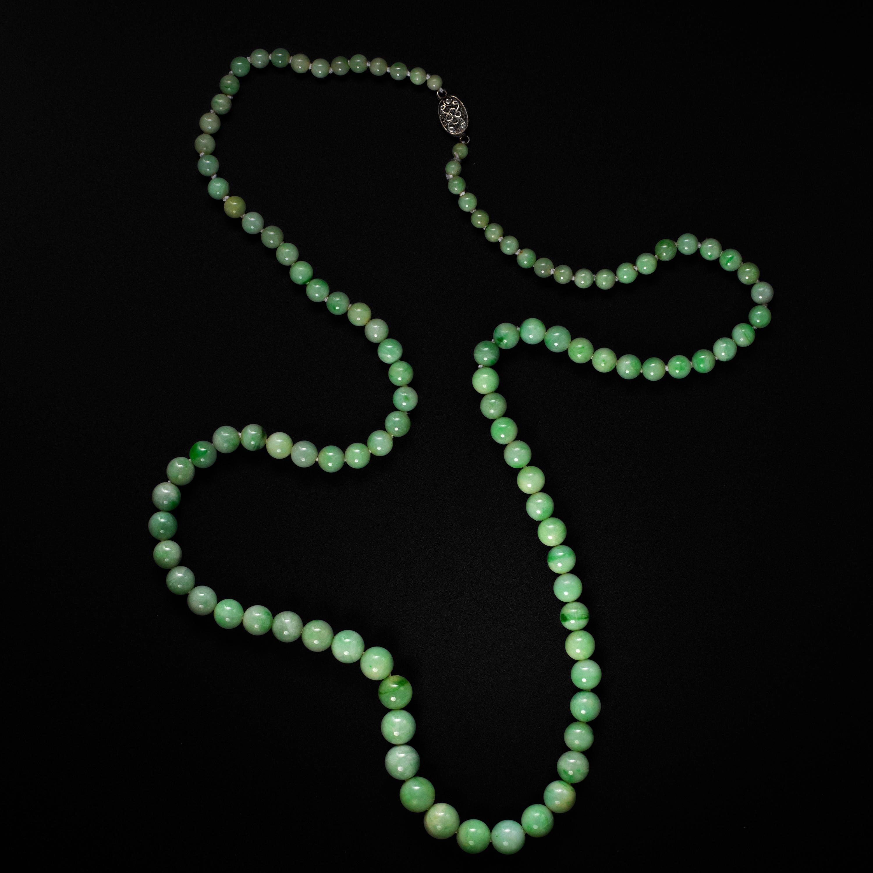 Bright, and filled with light, this radiant Art Deco era (circa 1920s -1930s) necklace is composed of 107 hand-carved and polished natural and untreated Burmese jadeite jade beads. The beads range in size from 4.13mm to 9.38.

Overall, the beads are