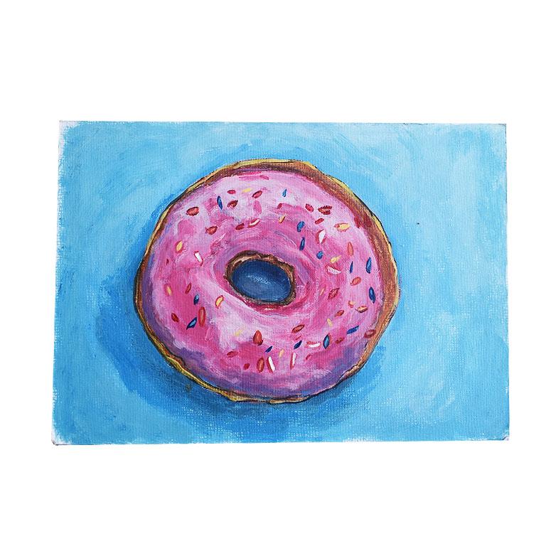 Small bright abstract outsider artist painting of a donut. This piece is on a blue background. The blue is bright and contrasts nicely with the colors of the donut. 

The round donut is the subject of the painting. With pink glazed icing and