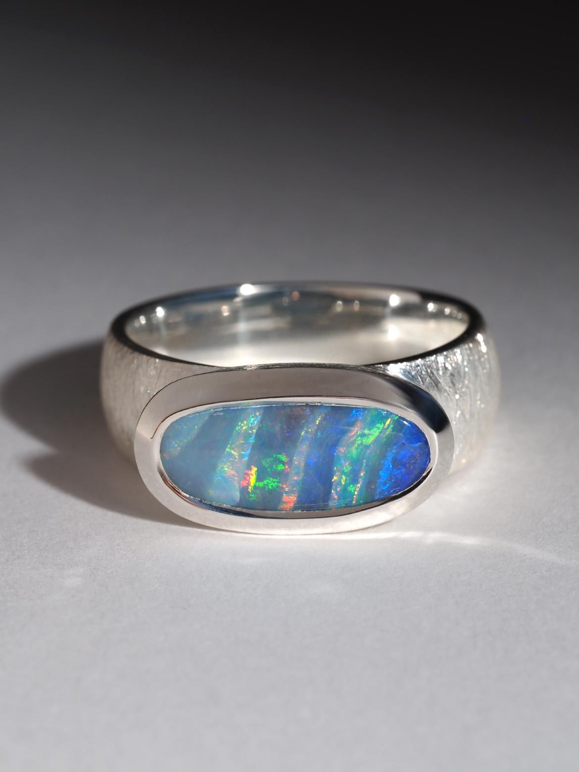 Silver ring with natural bright Boulder Opal
Opal gemstone origin - Australia
opal measurements  - 5 x 14 mm
ring weight - 7.5 grams
ring size - 8 US
weight of the Opal - 3.35 ct