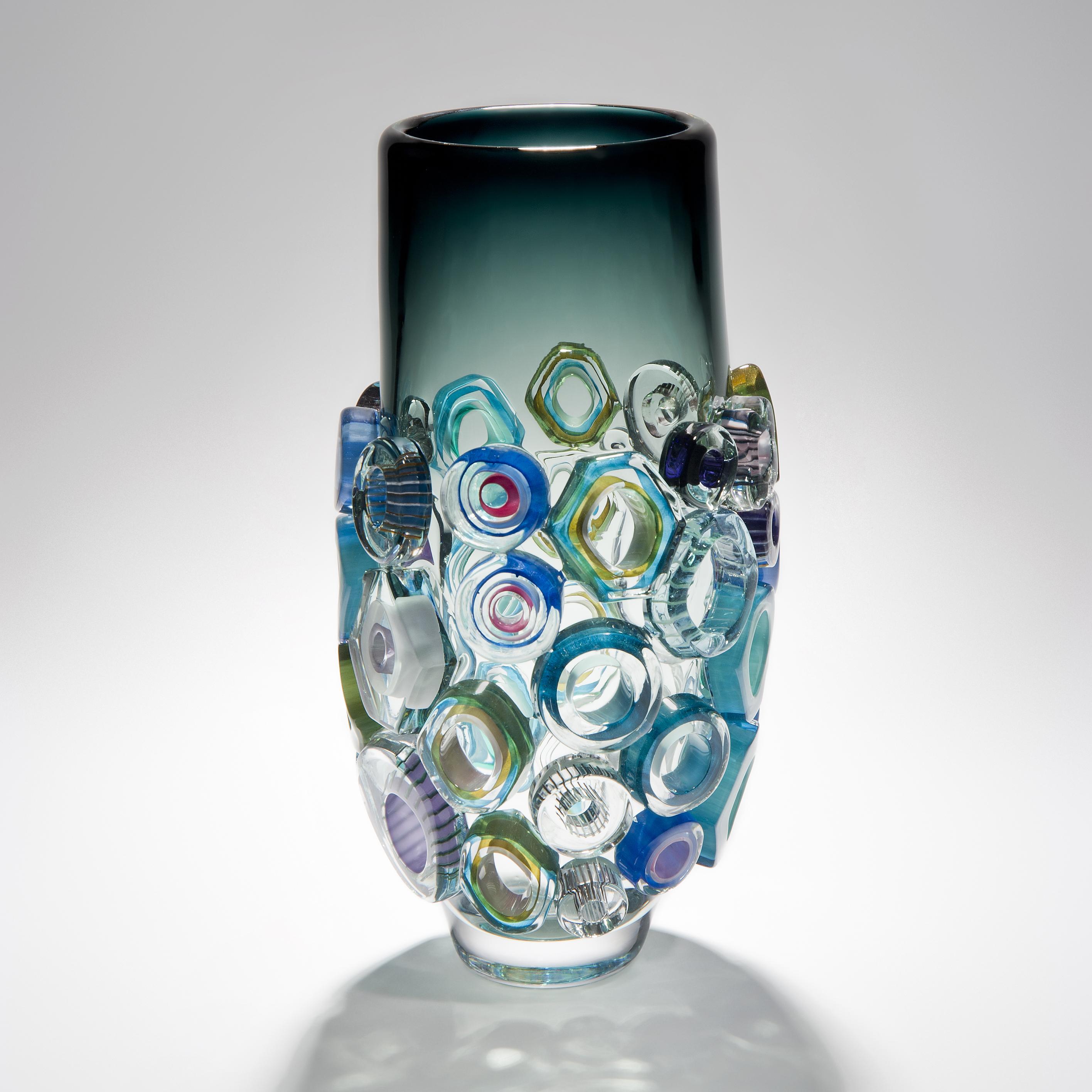 Bright field high shape with green diamonds is a unique hand blown and crafted vase by the German artist, Sabine Lintzen. The initial inner form is free-blown and adorned with various individually shaped murrini, all created in a mix coloured glass