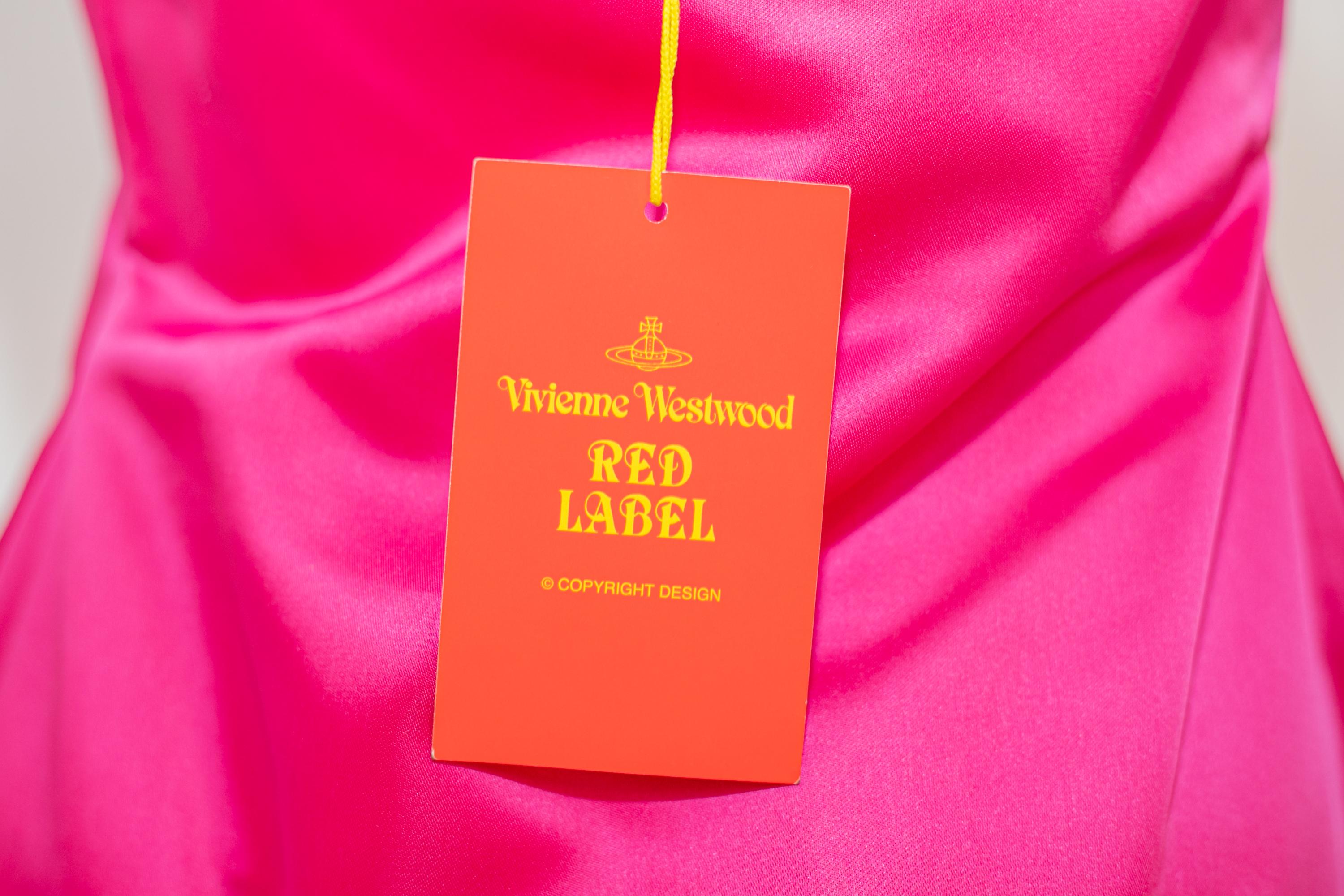 Important coloured cocktail dress designed by Vivienne Westwood in the 2000s, from the RED LABEL series.
The dress has the original label, of excellent Italian manufacture
The dress is made of a sparkling fuchsia fabric and is designed to be worn at