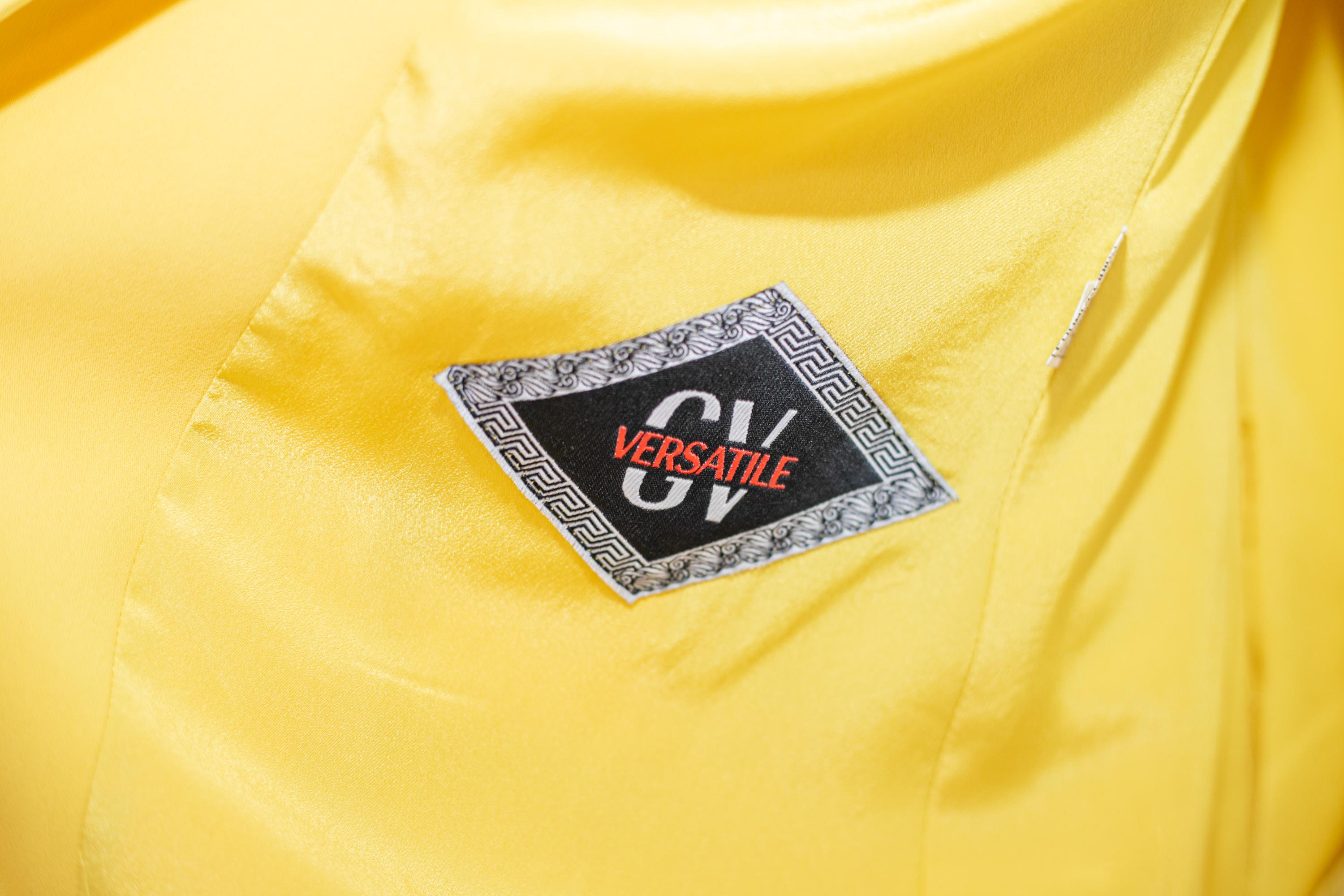 Robe jaune brillant conçue par Gianni Versace dans les années 1970, de belle facture italienne.
L'étiquette originale est présente à l'intérieur.
La robe se compose de deux pièces : la veste et la jupe.
La veste est une veste classique avec une