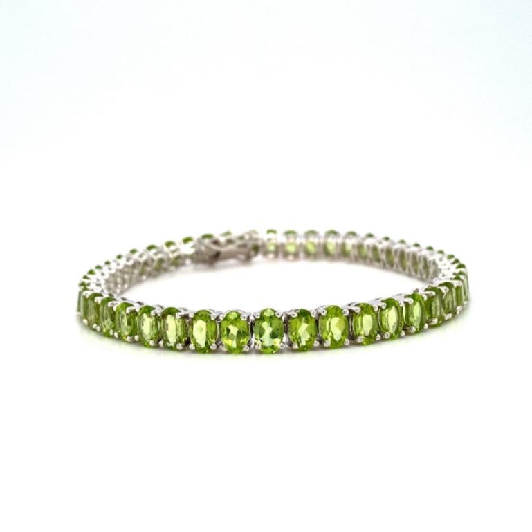 Oval Cut Bright Green Peridot Tennis Bracelet Set in Sterling Silver Settings For Sale