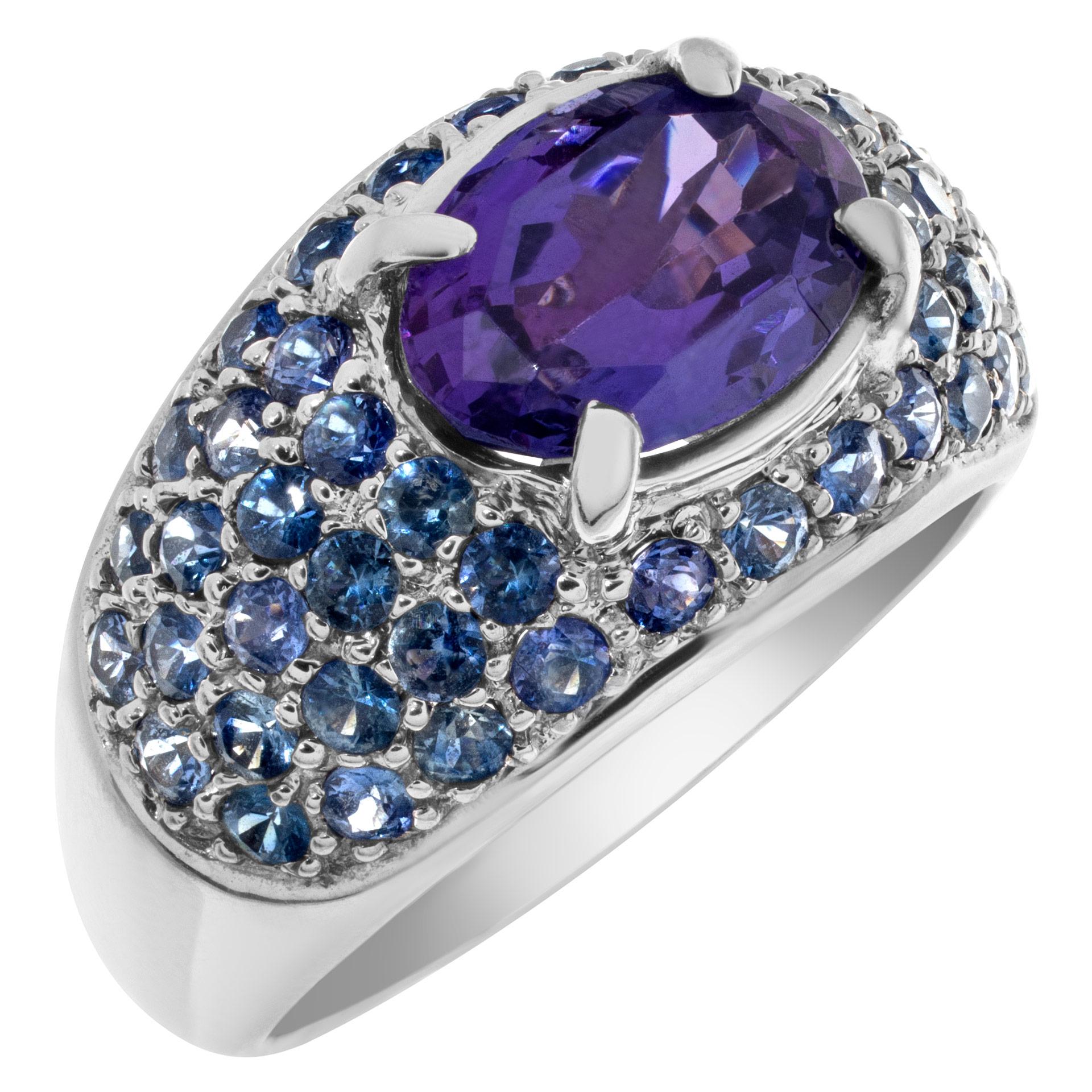 Bright oval center (approximately 2 carats) tanzanite surrounded by sparkling pave tanzanite gems in 14k white gold. Size 8.5.This Tanzanite ring is currently size 8.5 and some items can be sized up or down, please ask! It weighs 5.7 pennyweights