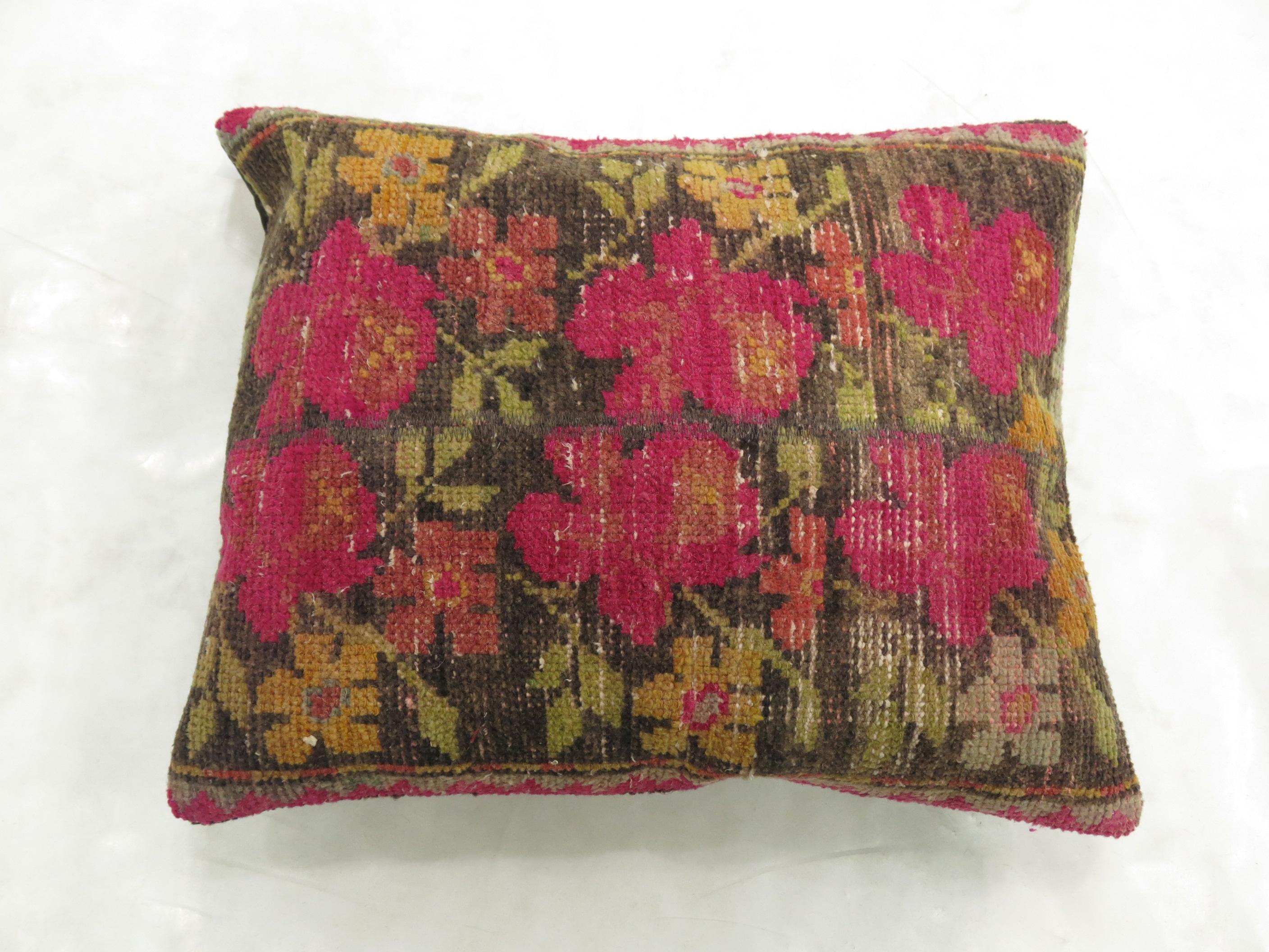 A large pillow made from a Turkish deco rug with a cotton back and zipper closure included. Bright pink and brown are the predominant colors

Measures: 19