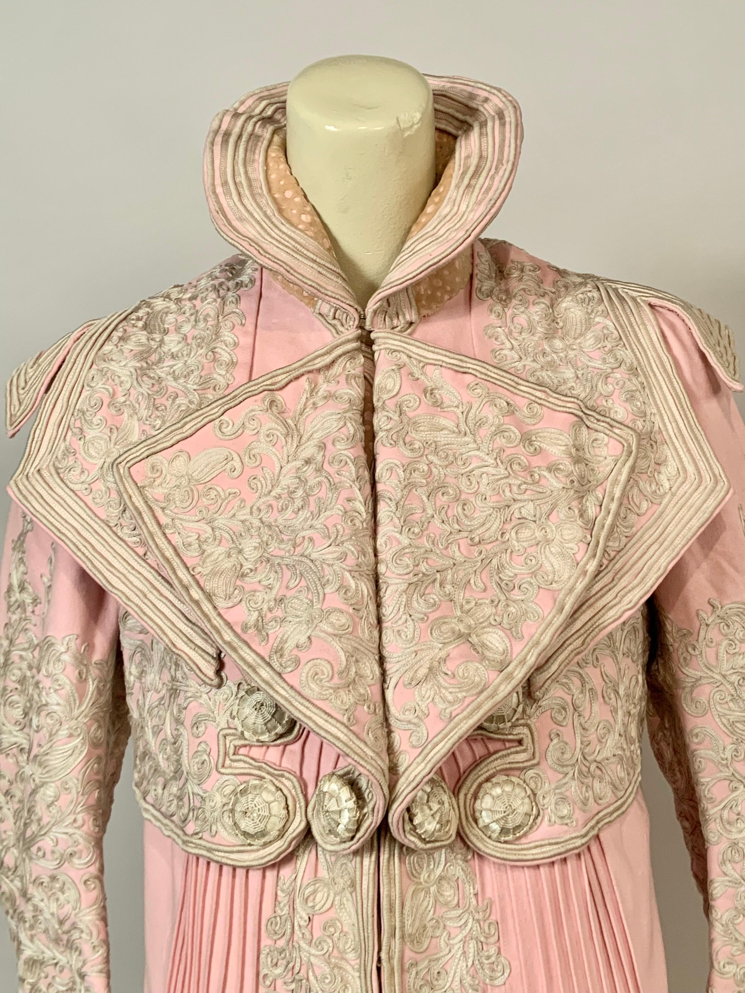 \\One of the prettiest coats I have ever owned, this bright pink wool coat is embellished with scrolling ribbon work decoration on the collar, bodice, sleeves, cuffs, the front of the coat, the hemline and the back of the coat. In addition, there