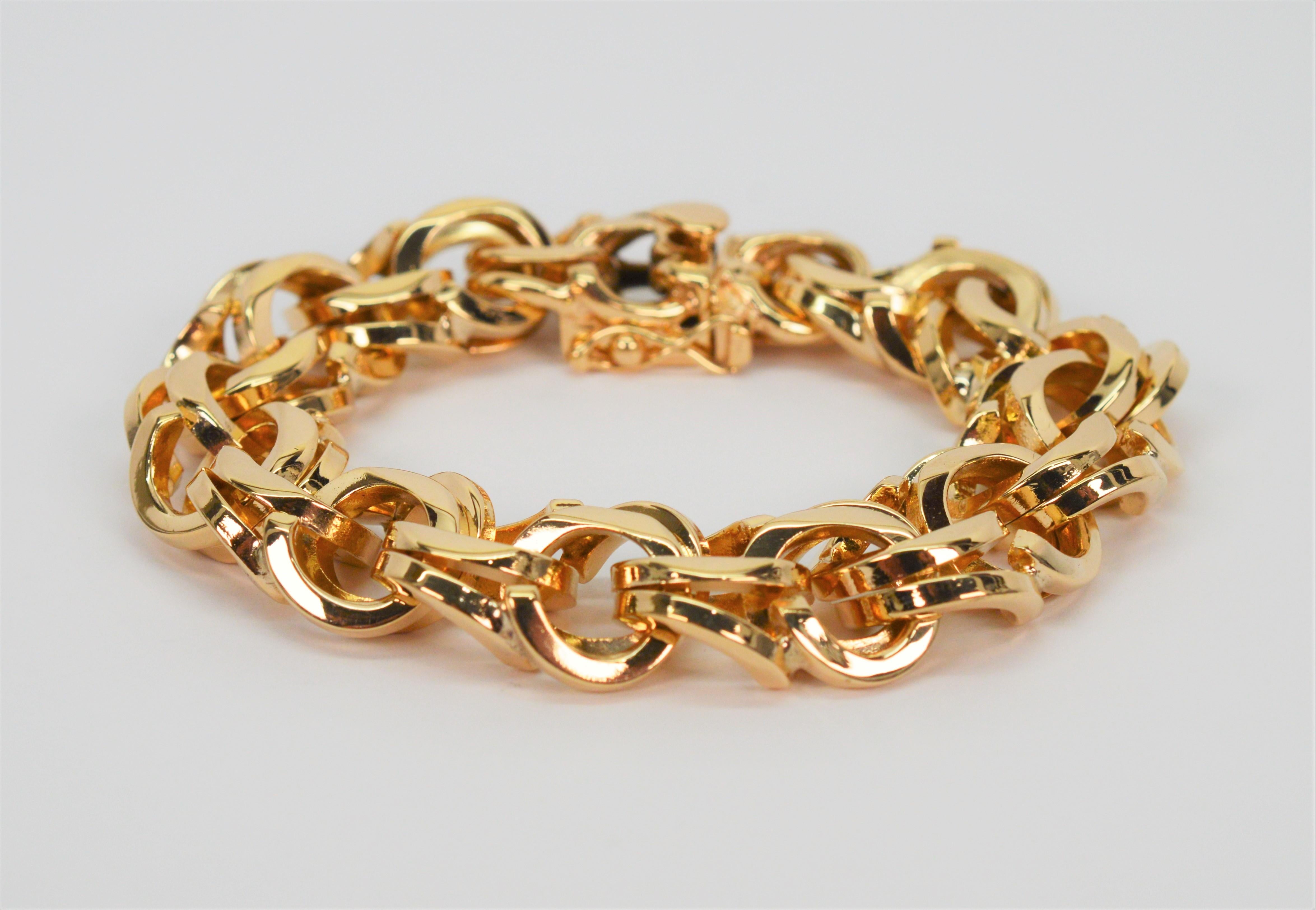 A timeless classic. Crafted in a heavy gauge highly polished fourteen karat 14K yellow gold, this fine quality 1950's vintage bracelet makes a bold statement with congruent 16mm double loop links to create this stunning 7 inch bracelet. The width of