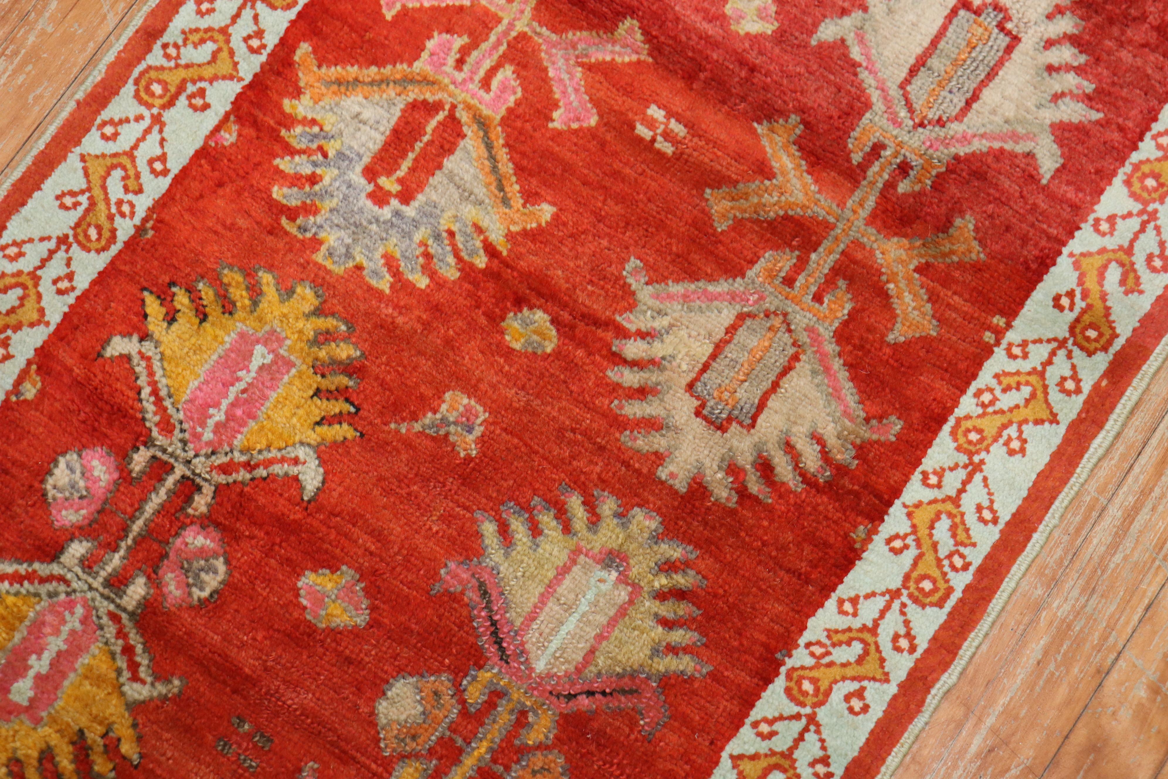 An early 20th century narrow and short antique oushak runner in red. 

Measures: 2'5'' x 6'6''.