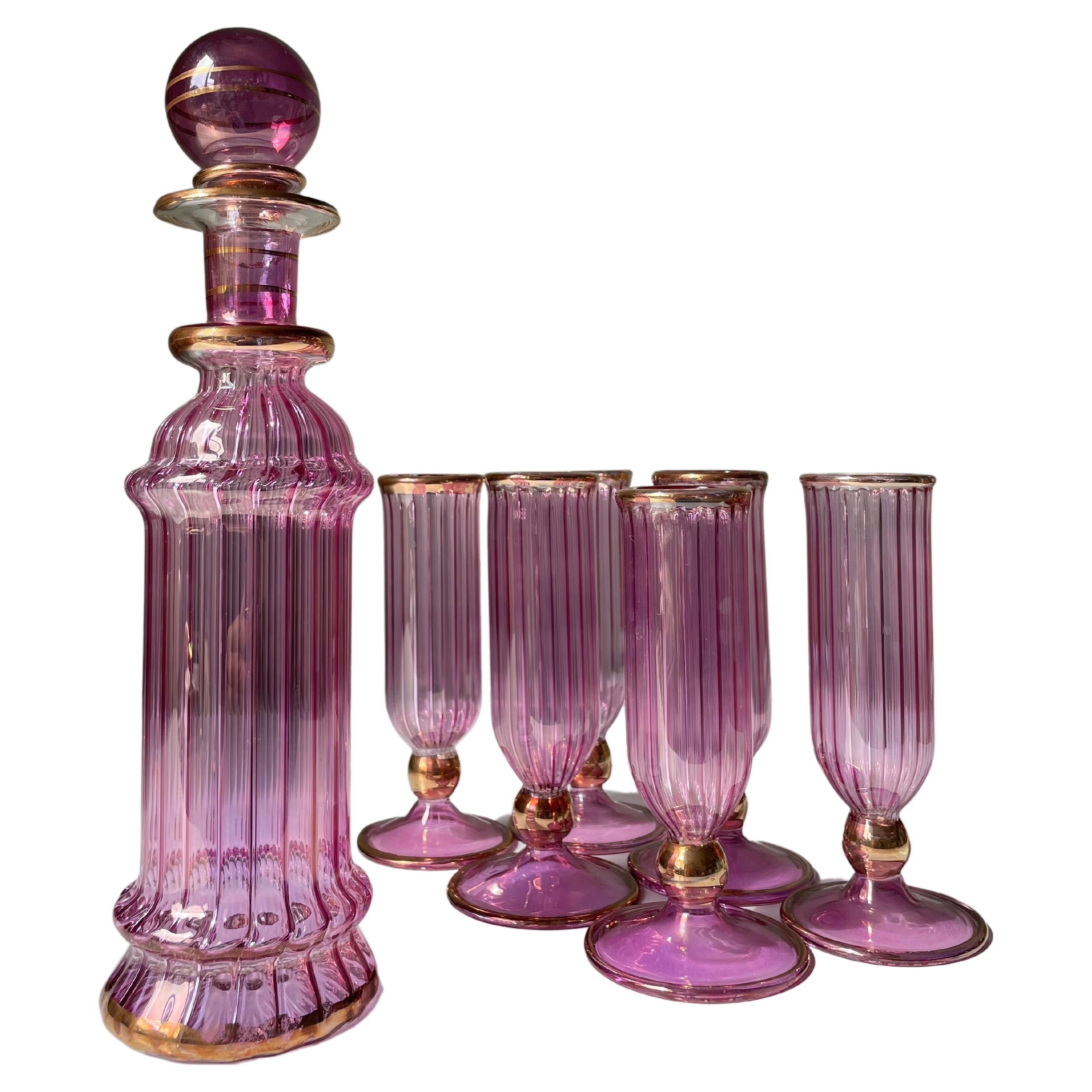 Eye-catching bright fuchsia pink striped set of Venetian Murano mouthblown art glass serveware. Slender carafe with soft tiers and large circular stopper (small chip on the inside of the stem of the stopper - no bearing on use or appearance). Six