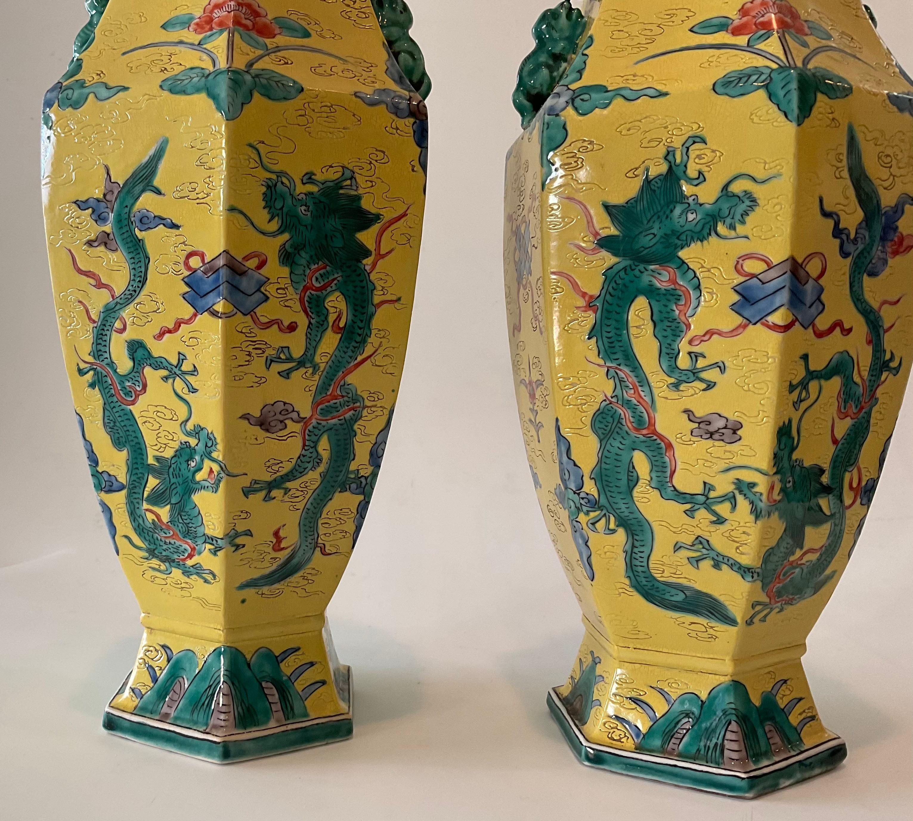 Bright Yellow Signed Chinese Pair of Porcelain vases with dragon decoration. Signature on bottom of each vase as shown.