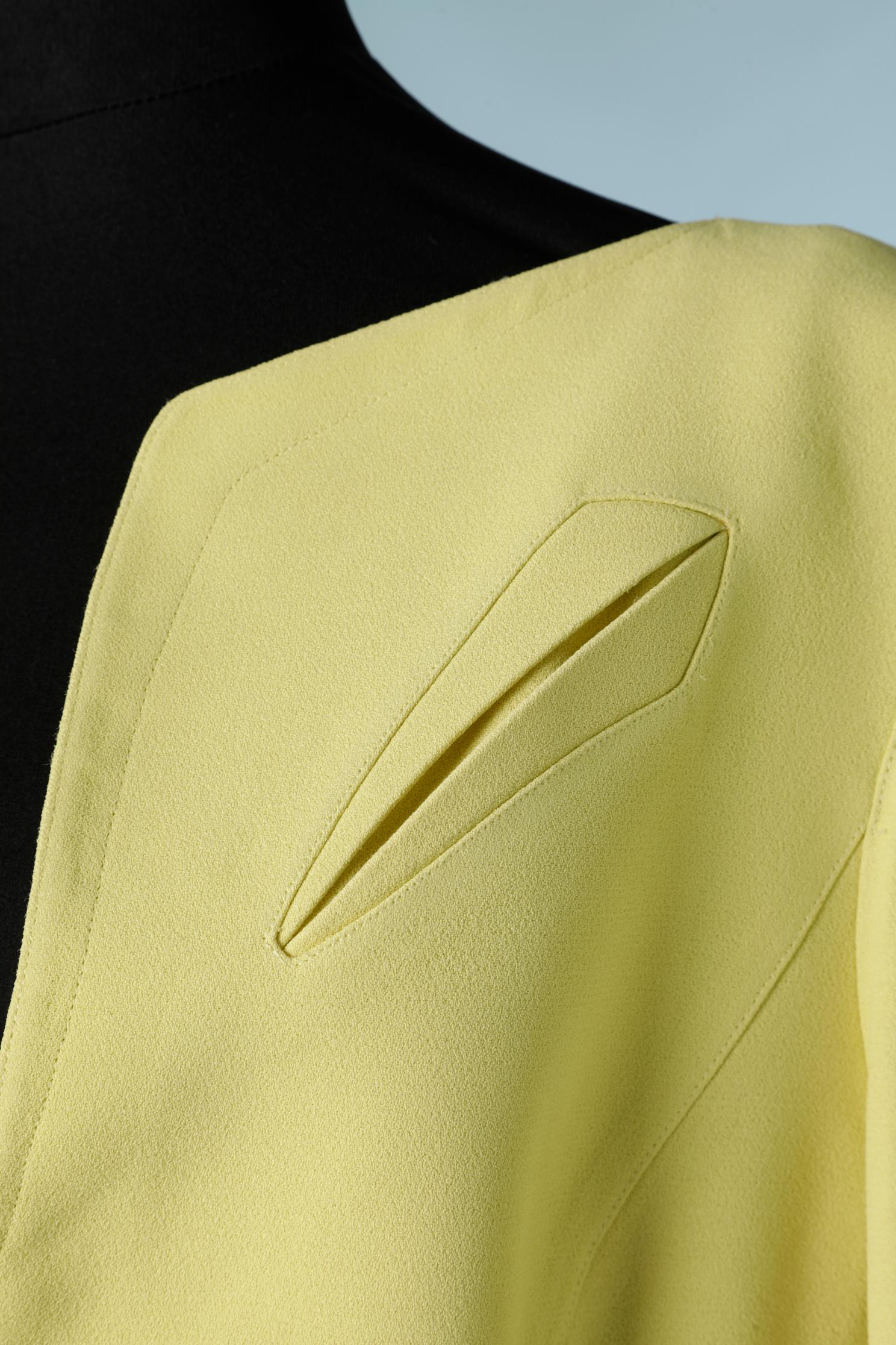 Bright yellow single breasted crêpe jacket with one snap in the middle front on the waist. 
Decorative pocket on the left above the left breast. 