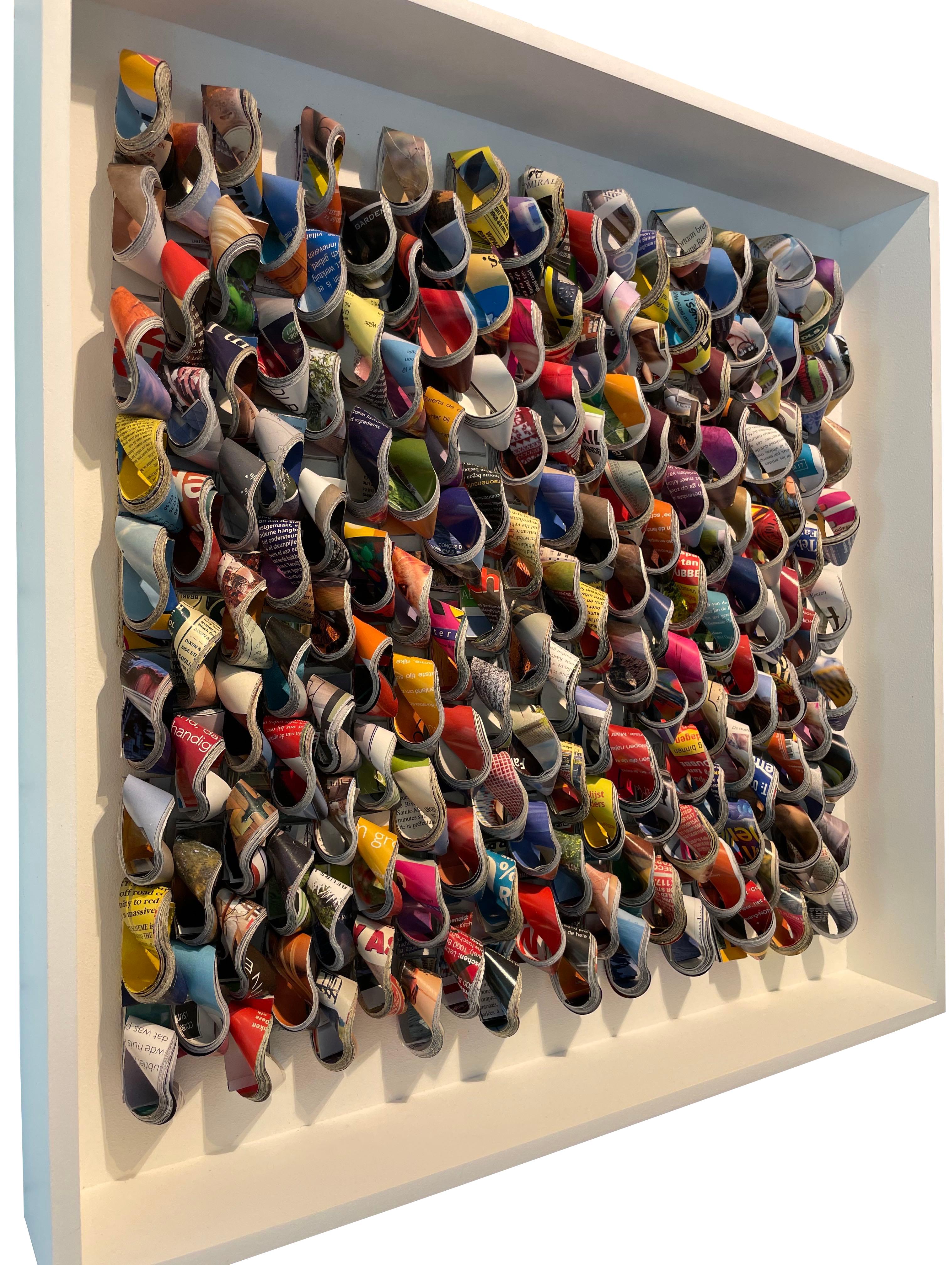 Contemporary Belgian artist Guy Leclef wall sculpture.
Cut pieces of brightly colored hand folded pages from various international magazines folded and placed to create
a unique and dramatic wall sculpture.
Folded paper housed in a thick lucite