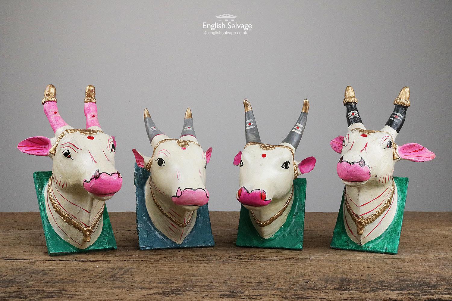 Holy cow head wall plaques reclaimed from India. Possibly made from papier-mâché, set on a wooden backplate with a ring for hanging. Overall size of each varies 11.8 - 15.7cm wide x 20 - 23.5cm high x 12.4 - 15.2cm deep. Please be aware that these