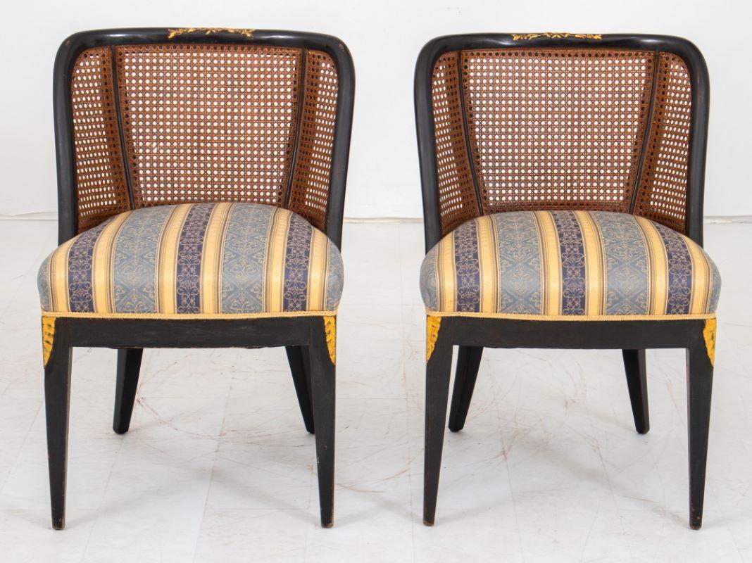 Pair of Regency Brighton Pavilion style carved and parcel gilded black-lacquered barrel chairs, each with curved crest rail above caned backs and damask upholstered seats above lacquered square tapering front legs. 

Dealer: S138XX