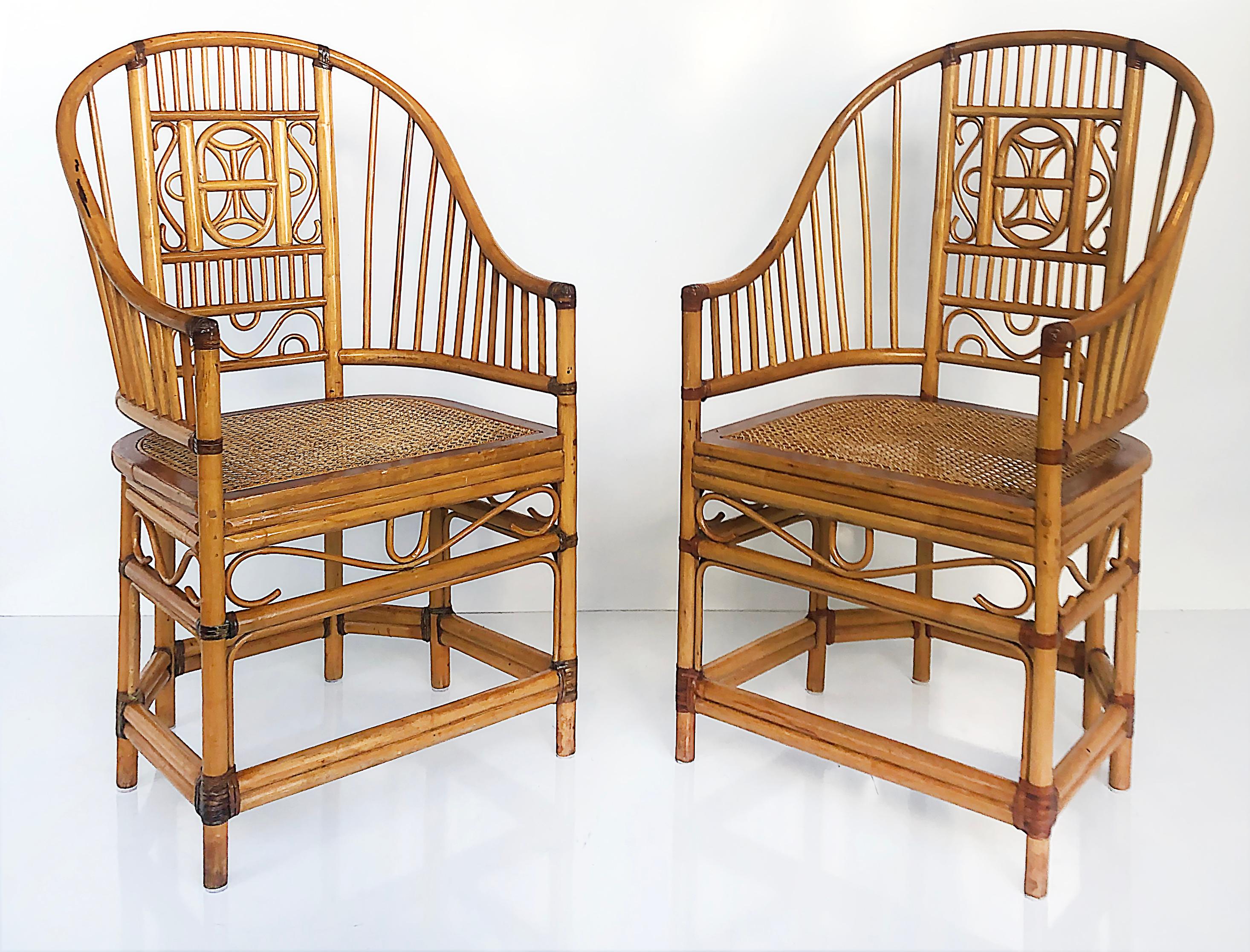 Offered for sale is pair of late 20th century 'Brighton Pavilion' bamboo and caned armchairs. The chairs have curved arms in a horseshoe shape that are supported by geometric designs in a Chinese Chippendale style. The chairs are supported by six