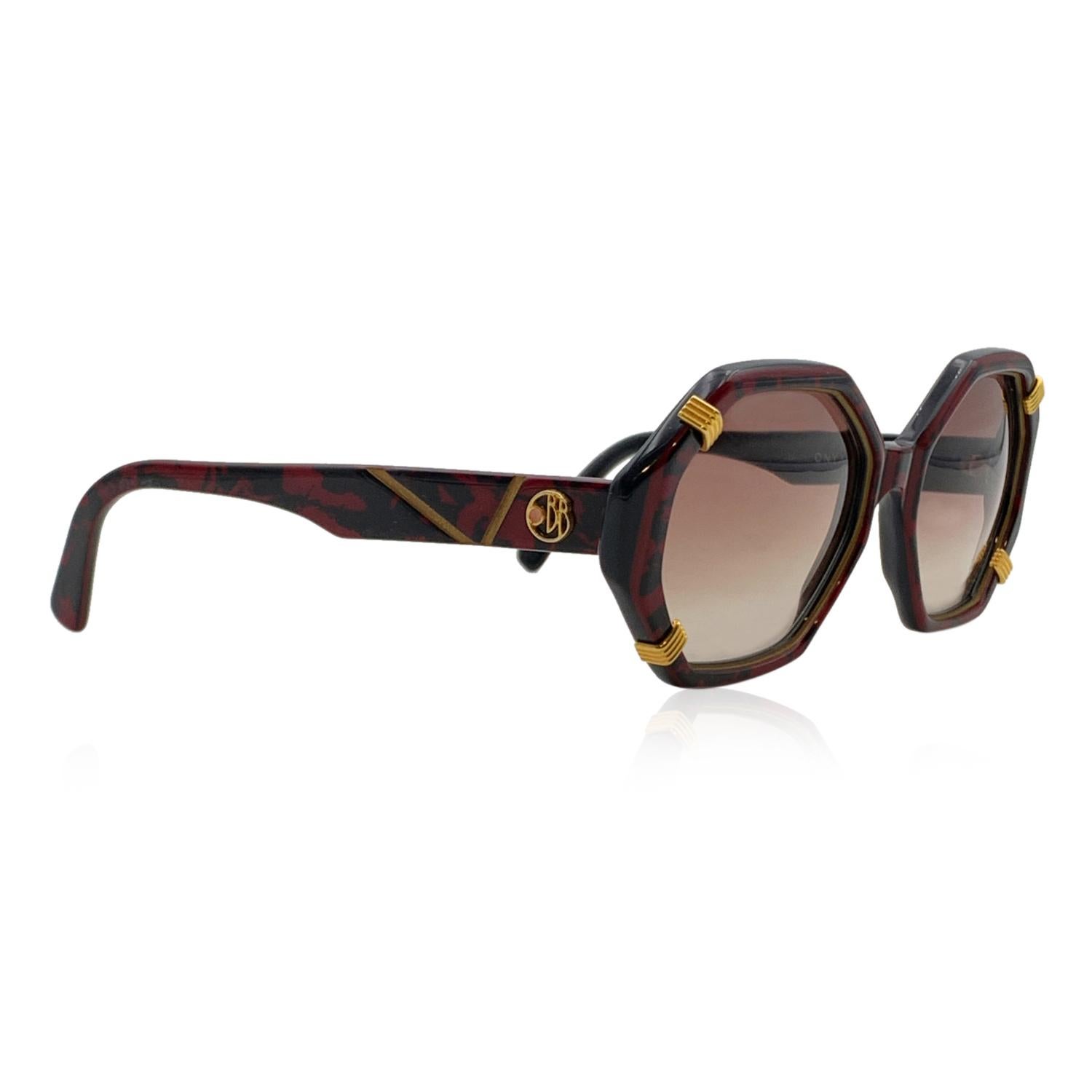 Beautiful Brigitte Bardot sunglasses from the 1970s, mod. Onyx CS 59. Beautiful black and burgundy acetate octagonal frame. Gradient brown lenses. Gold metal BB logo on temples and on the left part of the lens. Hand Made in