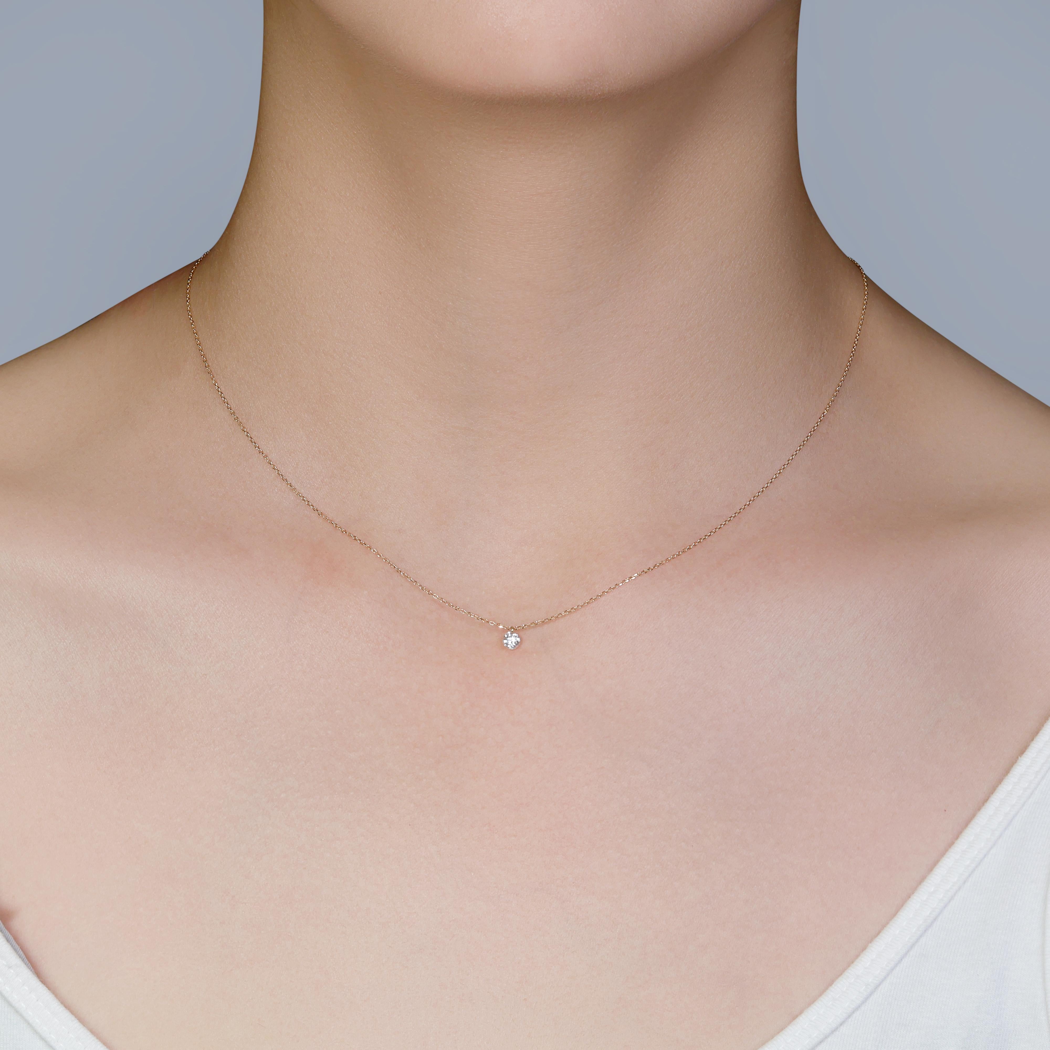 This exquisite piece of jewelry is beautifully crafted from 18K yellow gold, radiating warmth and elegance. At its center is a stunning round brilliant natural diamond, weighing 0.16 carats, graded G for color and VS for clarity, ensuring a