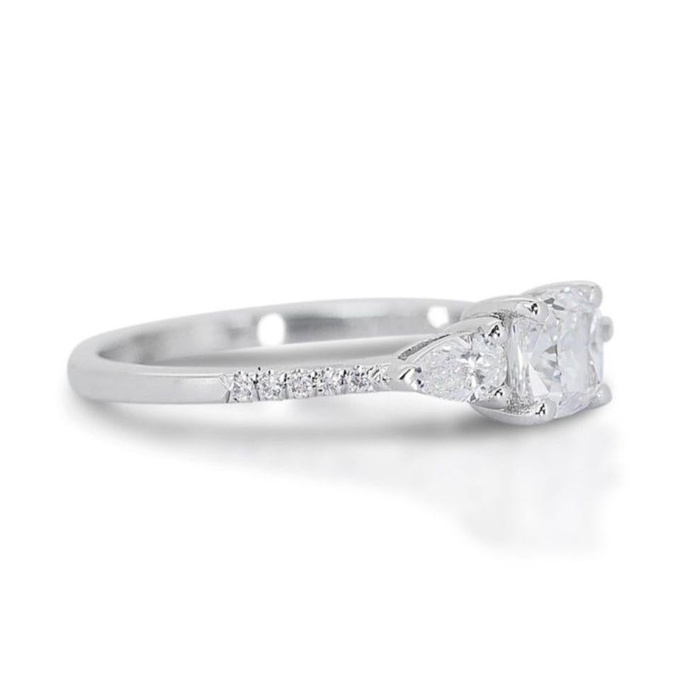 This ring is more than just an accessory; it's a statement piece that embodies timeless elegance and romantic charm. The cushion cut diamond offers a unique and captivating alternative to traditional round brilliants, while the shimmering side