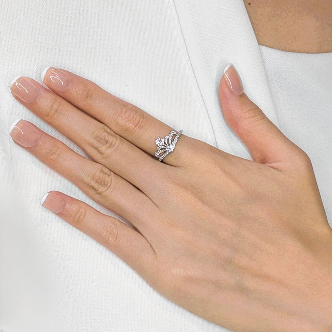 Crown your hand with this regal, unworn ring, featuring a unique tiara/crown-like design meticulously crafted in radiant 18K white gold. At its apex, two magnificent natural round brilliant diamonds, totaling a dazzling 0.43ct, radiate with