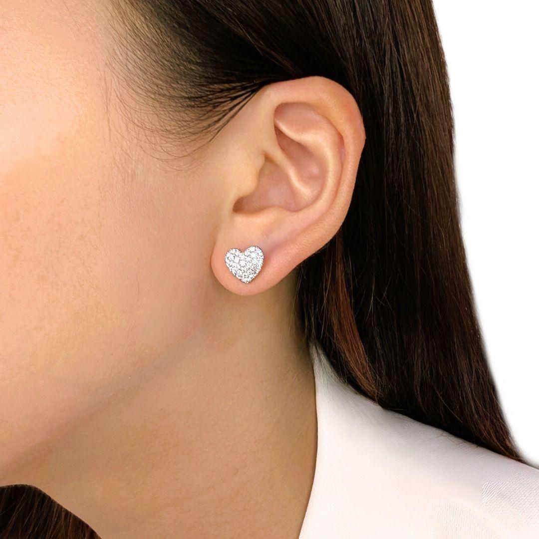 An elegant tribute to love and brilliance, these heart-shaped earrings are adorned with 66 natural diamonds, totaling 0.99 carats of dazzling sparkle. Each round brilliant-cut diamond, with its F-G color grade and VS clarity, is meticulously set in