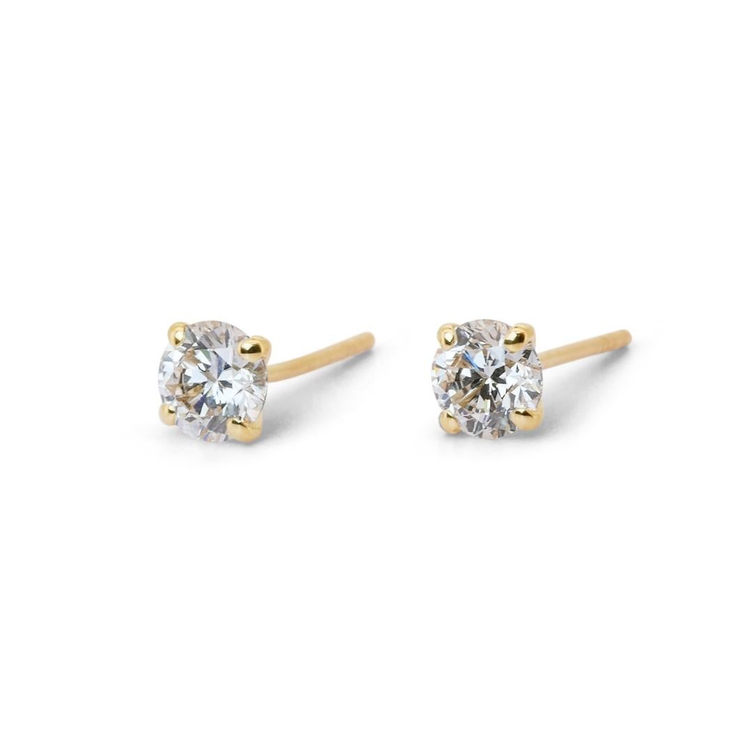 An enchanting stud earrings, with captivating display of elegance and luxury featuring two main diamonds with a combined weight of 1.41 carats. With an outstanding Clarity Grade of Internally Flawless (IF), these diamonds showcase a level of purity