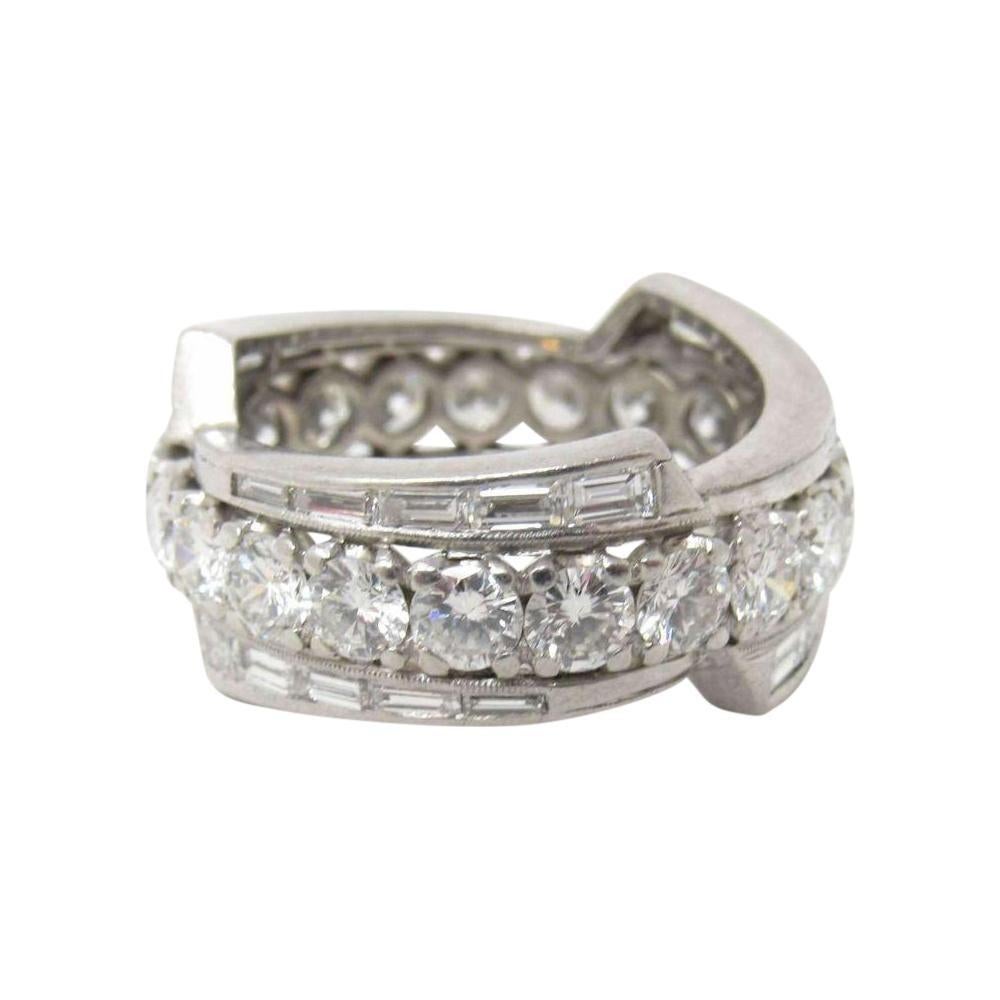 Featuring 21 round brilliant cut diamonds encircling the band and weighing 3.15 carats

Accented by 30 baguette diamonds weighing 1.50 carats

Diamonds are colorless and clean, E-F color and VS clarity

Measures 9 mm at widest point

Tested as