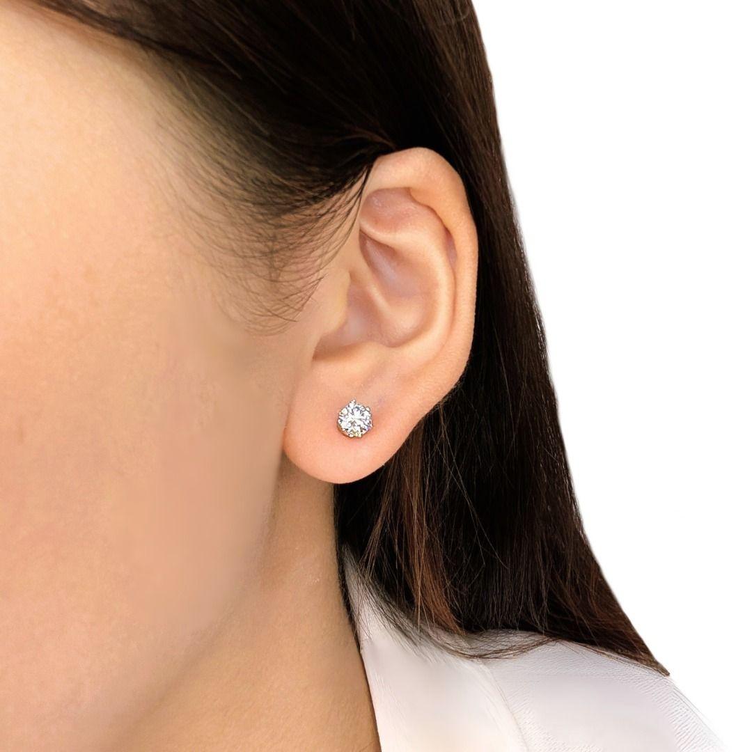 Experience timeless brilliance with these essential classic diamond stud earrings, expertly crafted in bright 18K white gold. Each earring showcases a substantial 0.50-carat natural round brilliant diamond, meticulously chosen to create a