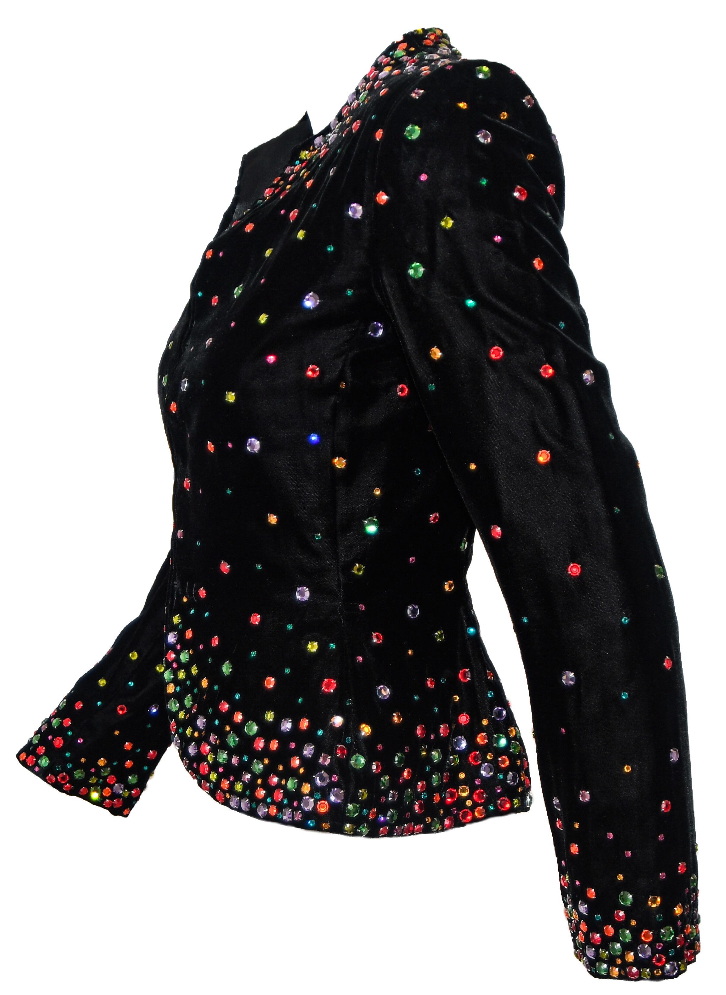 Bill Blass vintage black velvet tapered jacket incorporates hundreds of brilliant multicolored crystals throughout.  Each stone is set in prongs like the gems they represent!  This garment is accentuated with fuller coverage of the crystals around