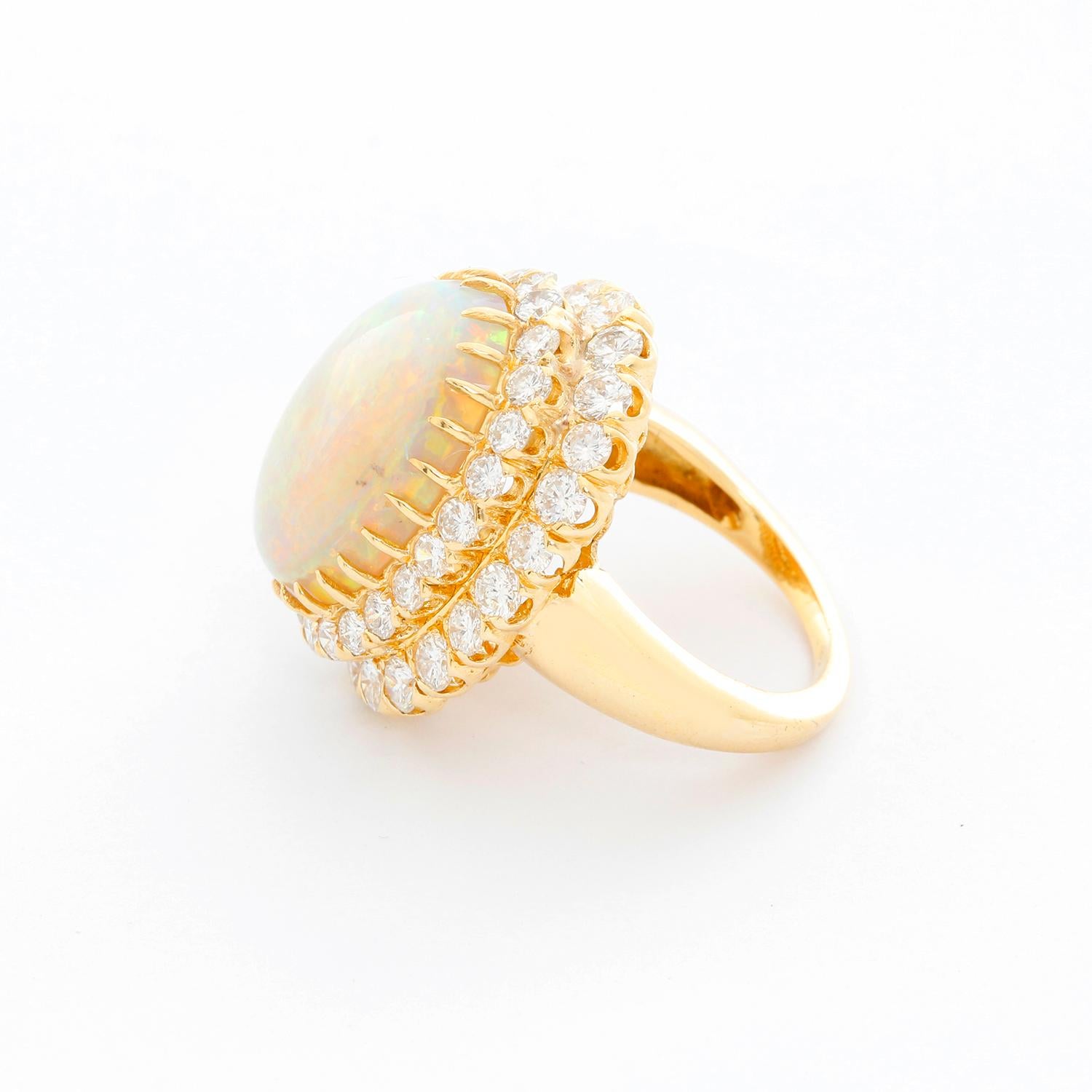 Brilliant Crystal Opal and Diamond Yellow Gold Ring Size 6.5 - Beautiful Crystal Opal ring weighing approx. 8 cts. set in 14K Yellow gold surrounded by a two rows diamonds. Diamond total weight is approx. 3 cts.  Total weight  14.3 grams. Ring size