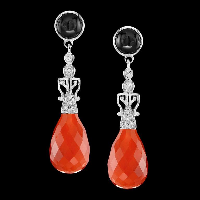 A pair of Brilliant Cut Carnelian drops 14.75 ct. swing and sway below a pair of sparkling diamonds (12 pcs. 0.18 ct.) and round onyx (2 pcs. 1.61 ct.) setting in Art Deco Style Earrings. They are crafted in 9K White Gold. You could wear earrings