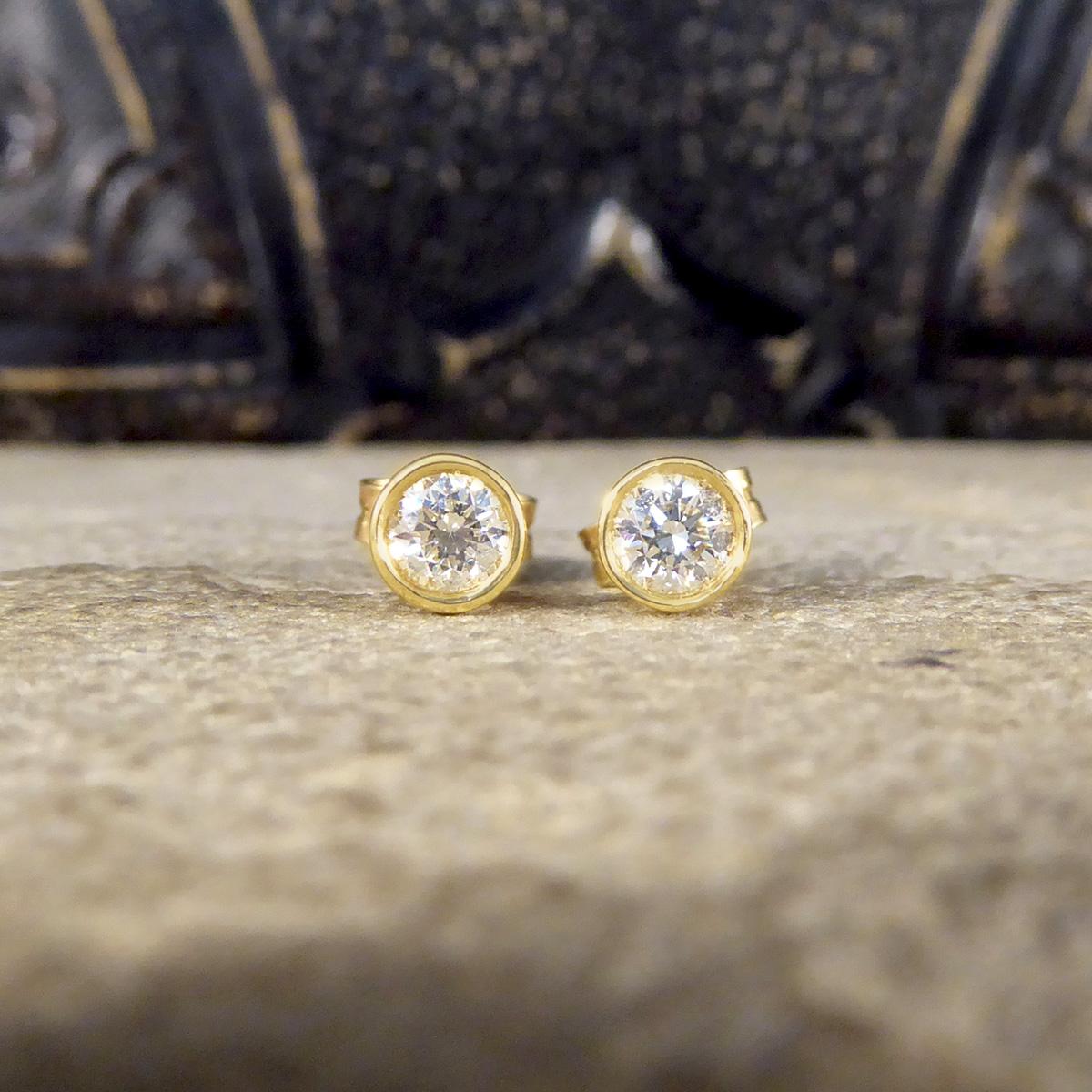 The perfect pair of Yellow Gold set stud earrings. Each stud is set with a 0.25ct Round Brilliant Cut Diamond, matching well in colour and clarity and weighing a total of 0.50ct. Each Diamond sits in a Yellow Gold basket with a rub over collar