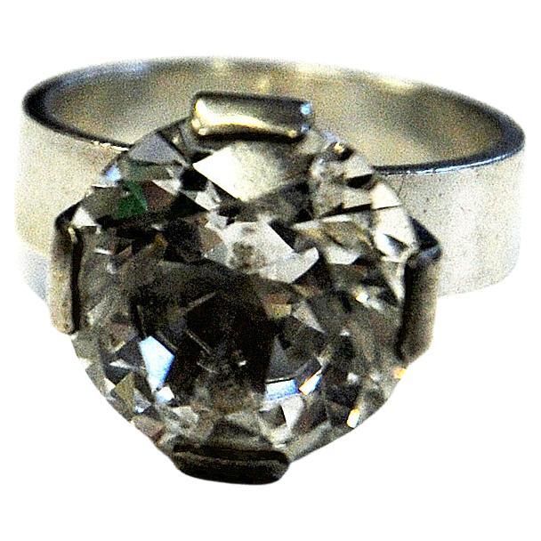 Silverring with a lovely brilliant cut rock crystal stone in the middle made by Ceson Guldvaru AB 1967, Sweden. Great midcentury ring with a lovely diamond shaped stone and a solid silverbase emracing it. Perfect for both parties or everday use. The