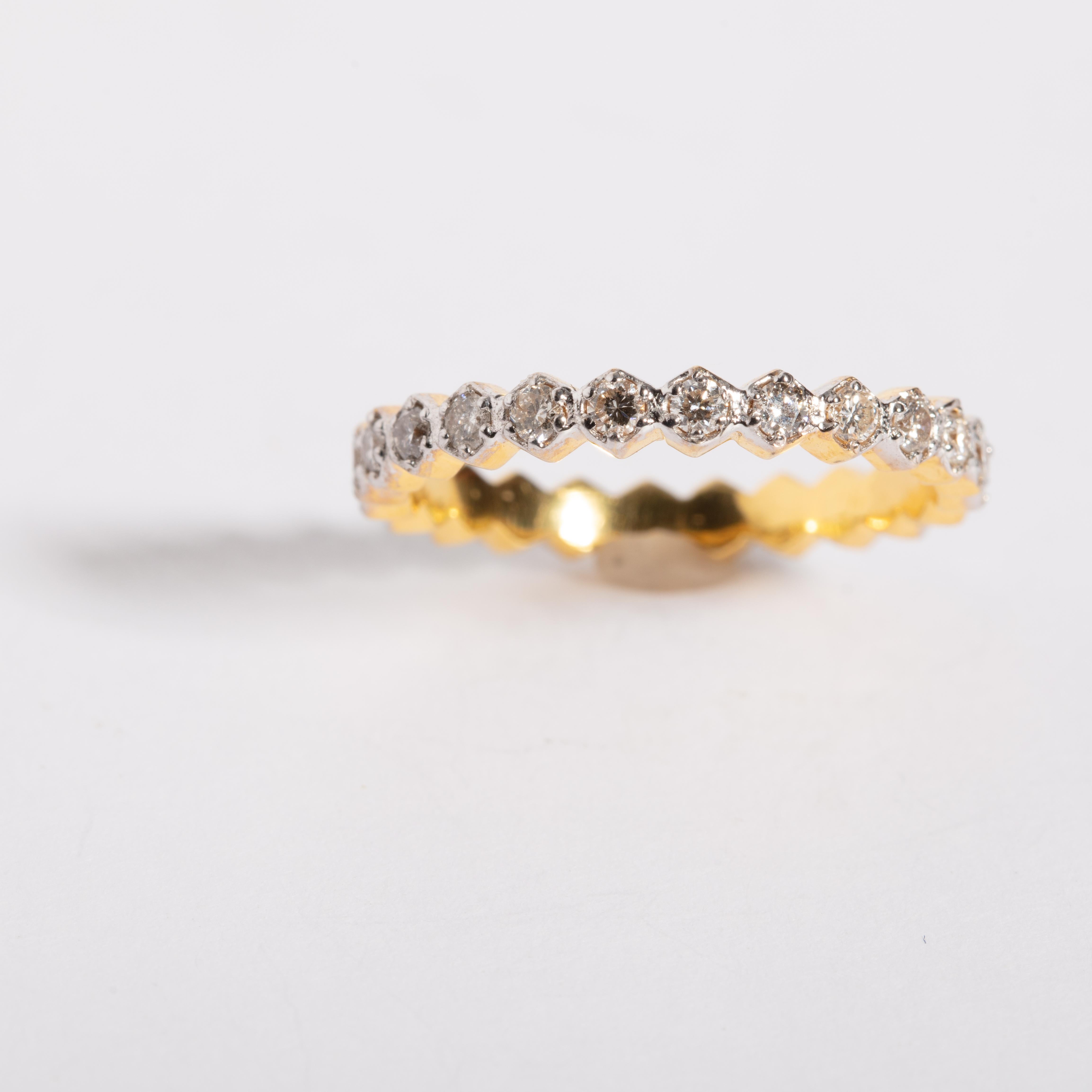 An eternity 18K gold band of round, brilliant cut diamonds.  Carat weight is .64.  Ring size is 7.25.  Use as a wedding band or stack with others.