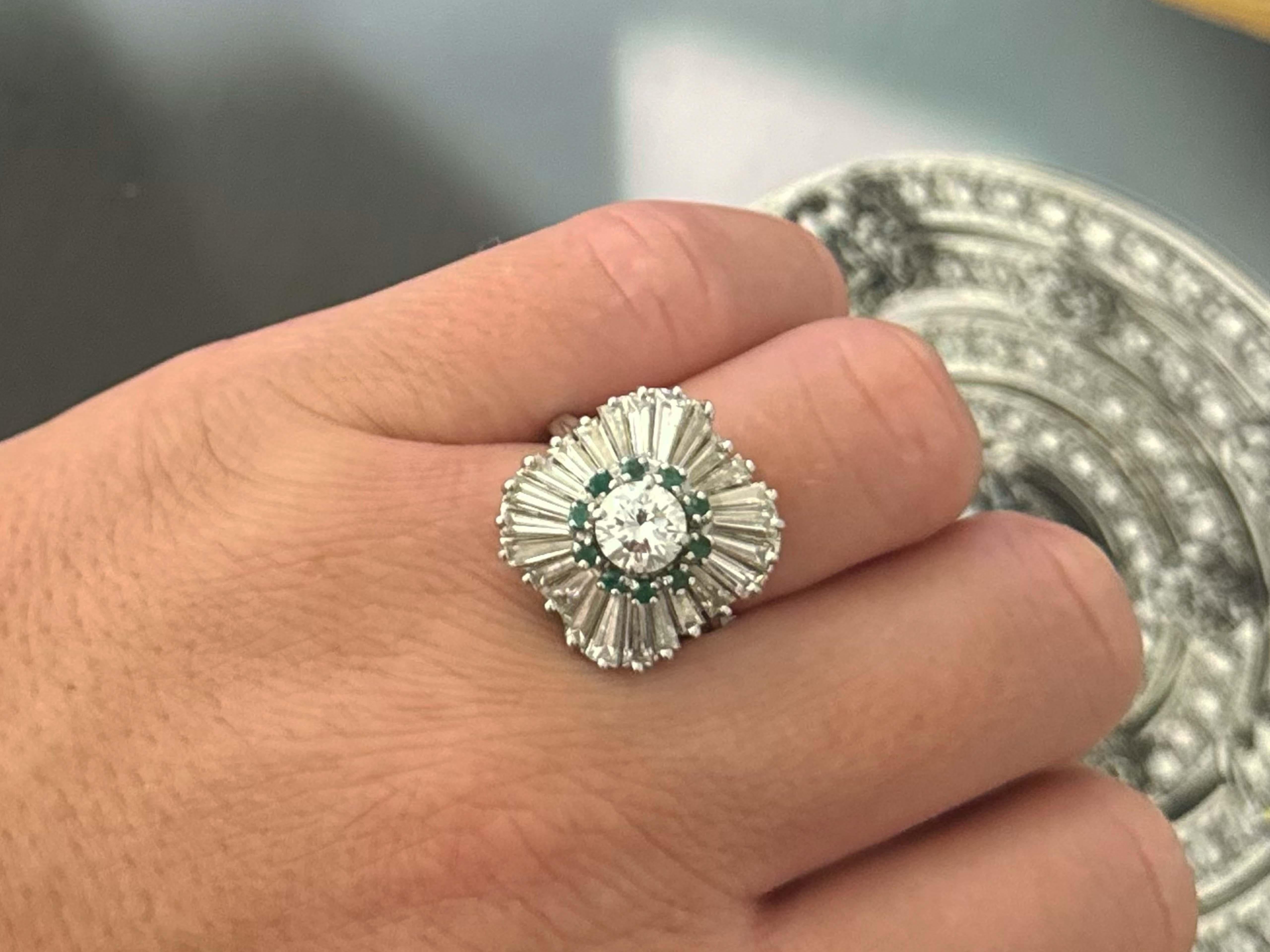 Ring Specifications:

Metal: Platinum 900

Ring Size: 6.5
​
​Ring Height: 19 mm tall
​
​Ring Weight: 10.2 grams

Emerald Count: 10 round green emeralds (~1.9 mm in diameter)

Emerald Carat Weight: ~0.30 carats

Center Diamond