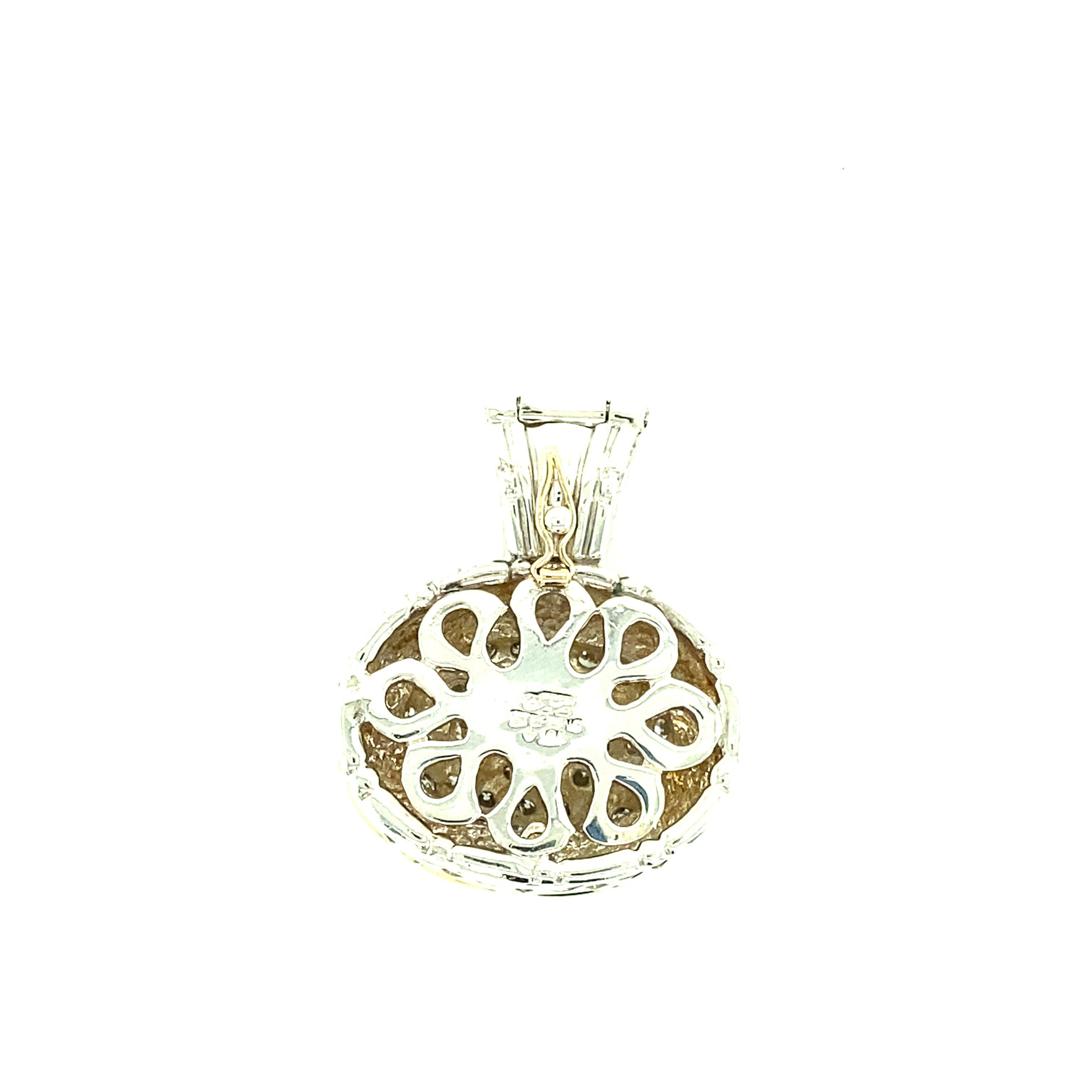 One 18 karat yellow gold and sterling silver (stamped Sterling & 18K) estate pendant set with forty-four brilliant cut diamonds, 1.20 carats total weight with matching I/J color and SI clarity.  The pendant measures 1.25 inches long and one inch