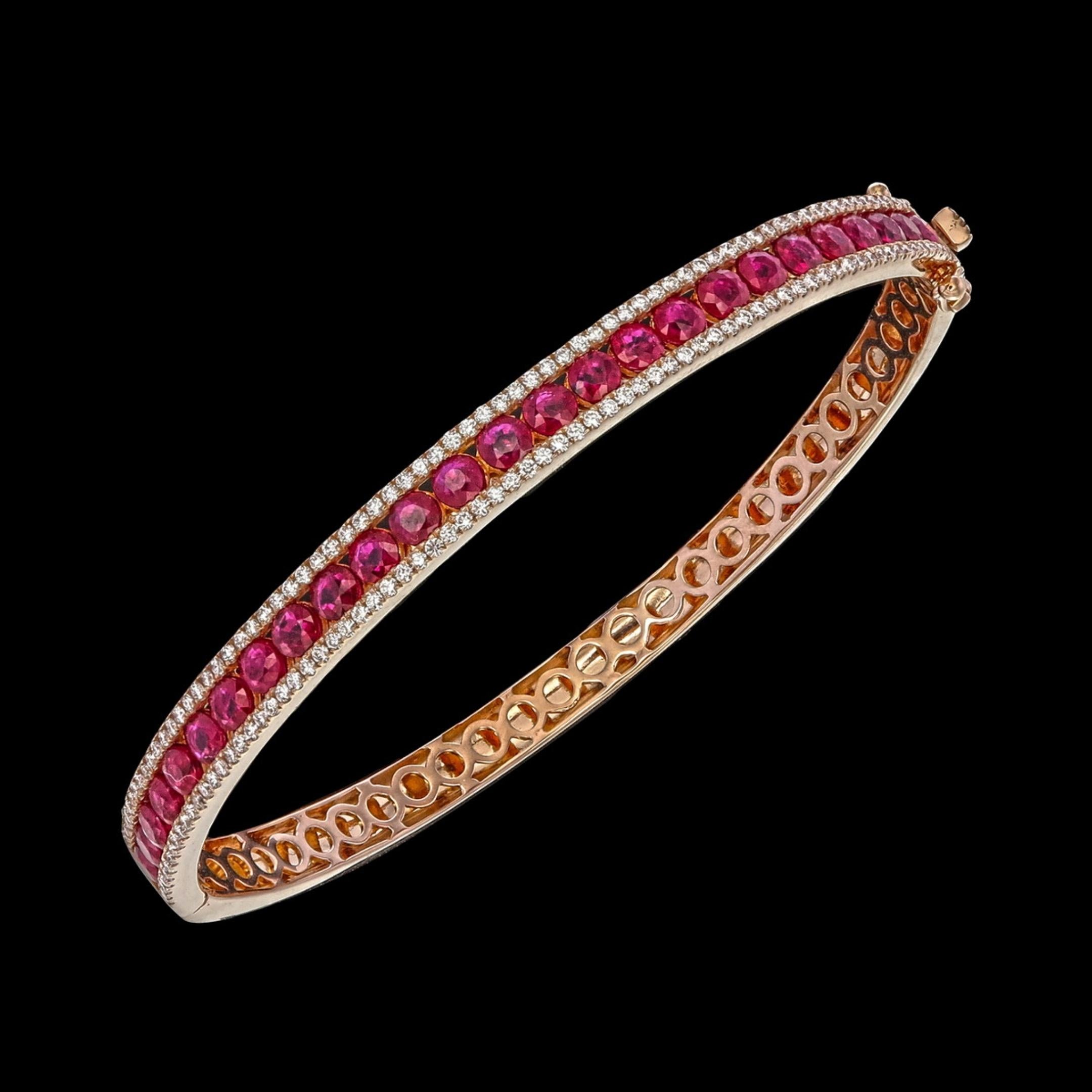 This exquisite 18K yellow gold ruby and diamond bangle captures timeless sophistication and modern artistry. Meticulously handcrafted, it features a continuous row of fine vivid red round rubies, beautifully framed by two delicate lines of