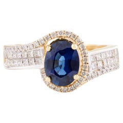 Verlobungsring aus 18 Karat Gelbgold mit Brillanten und tiefblauem Saphir und Diamant in Nieten