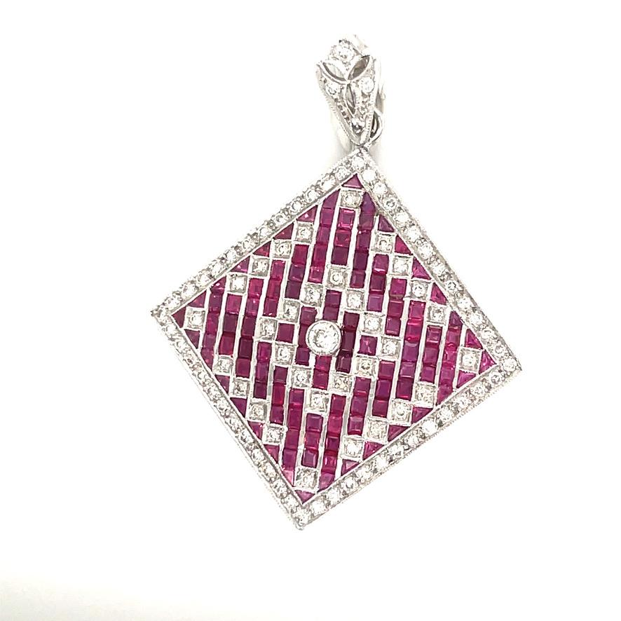 Dramatic diamond and ruby pendant/pin. 18K white gold with lovely diamond bail.  Set in a striking geometric pattern.
Vibrant color rubies.  1 1/8