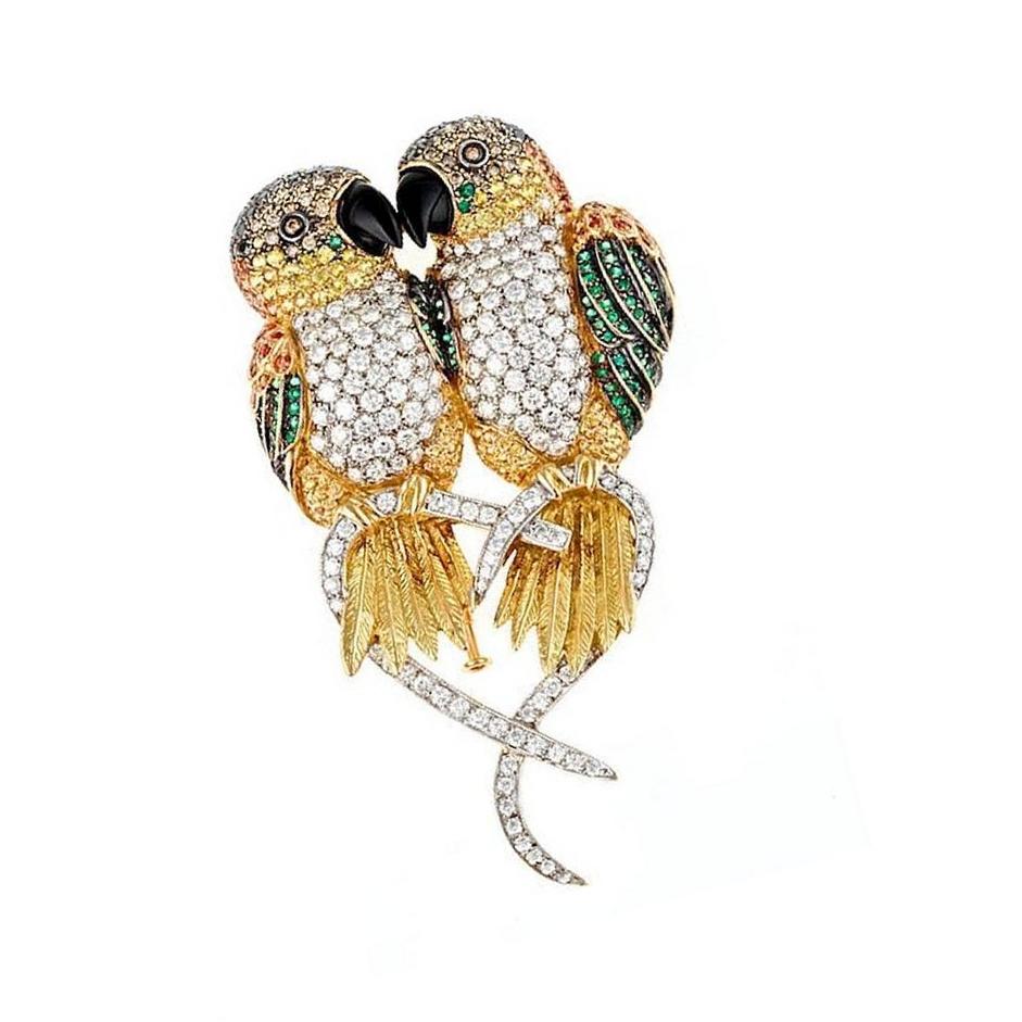 18k. White Gold. 163 Brilliant Round Diamonds (6.4ct). 51 Orange and Yellow Sapphires (.71ct). 108 Emeralds (.71ct). Angel and Peter enjoy an unusually quiet moment with you. This piece was made in Manhattan entirely by hand, and was cast, one at a