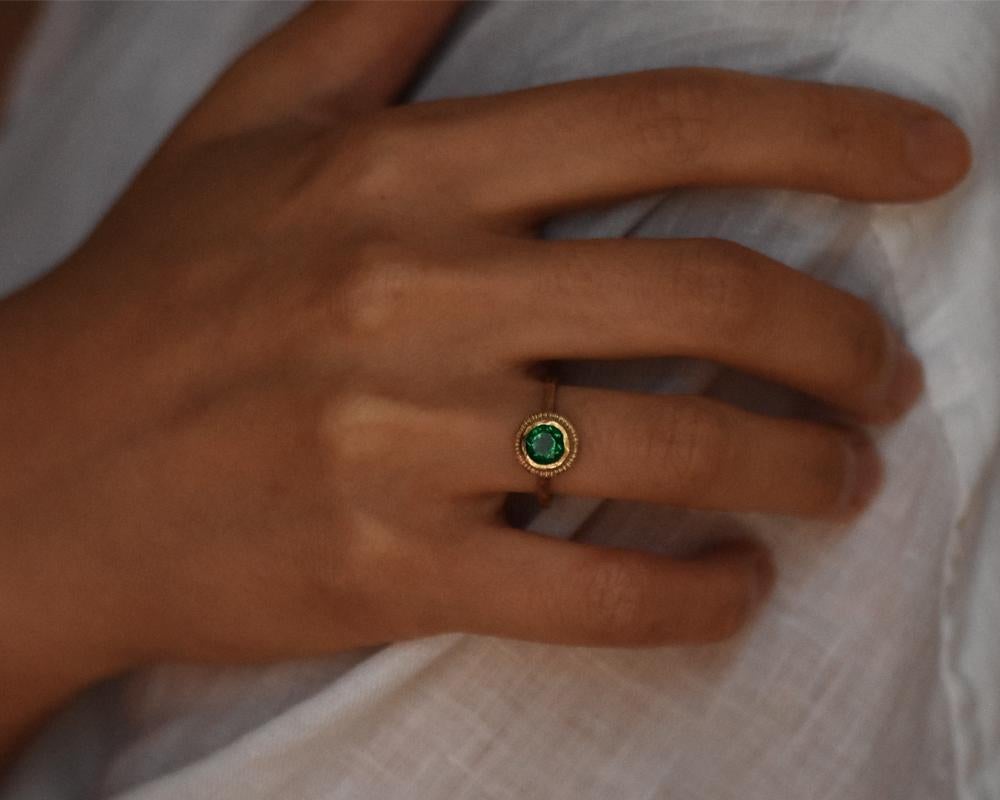 This one-of-a-kind 14k gold ring features a stunning emerald with three diamonds set at the back of the band. Paying homage to tradition, the ring has been formed from scratch using heirloom tools from Franny's Father and Grandfather. The organic