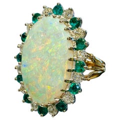 Brilliant Fire 9.6 Carat Oval Opal Diamond and Emerald Halo Two-Tone Gold Ring