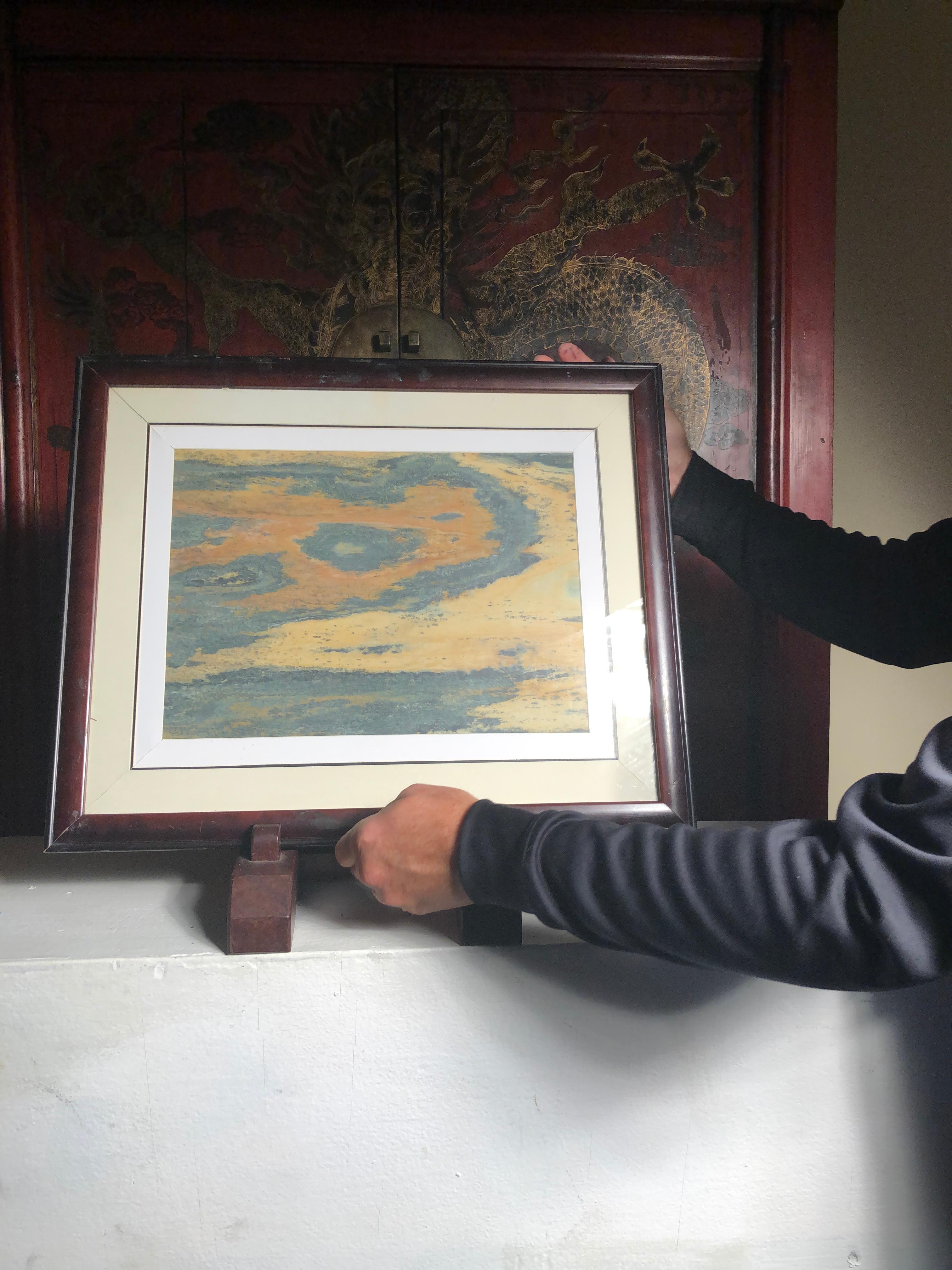 Extraordinary natural work, one of a kind. Custom framed

This Chinese extraordinary round natural stone painting of a possible brilliant swirl or scene could remind us of a unique experience and view in our lives. The powerful and colorful