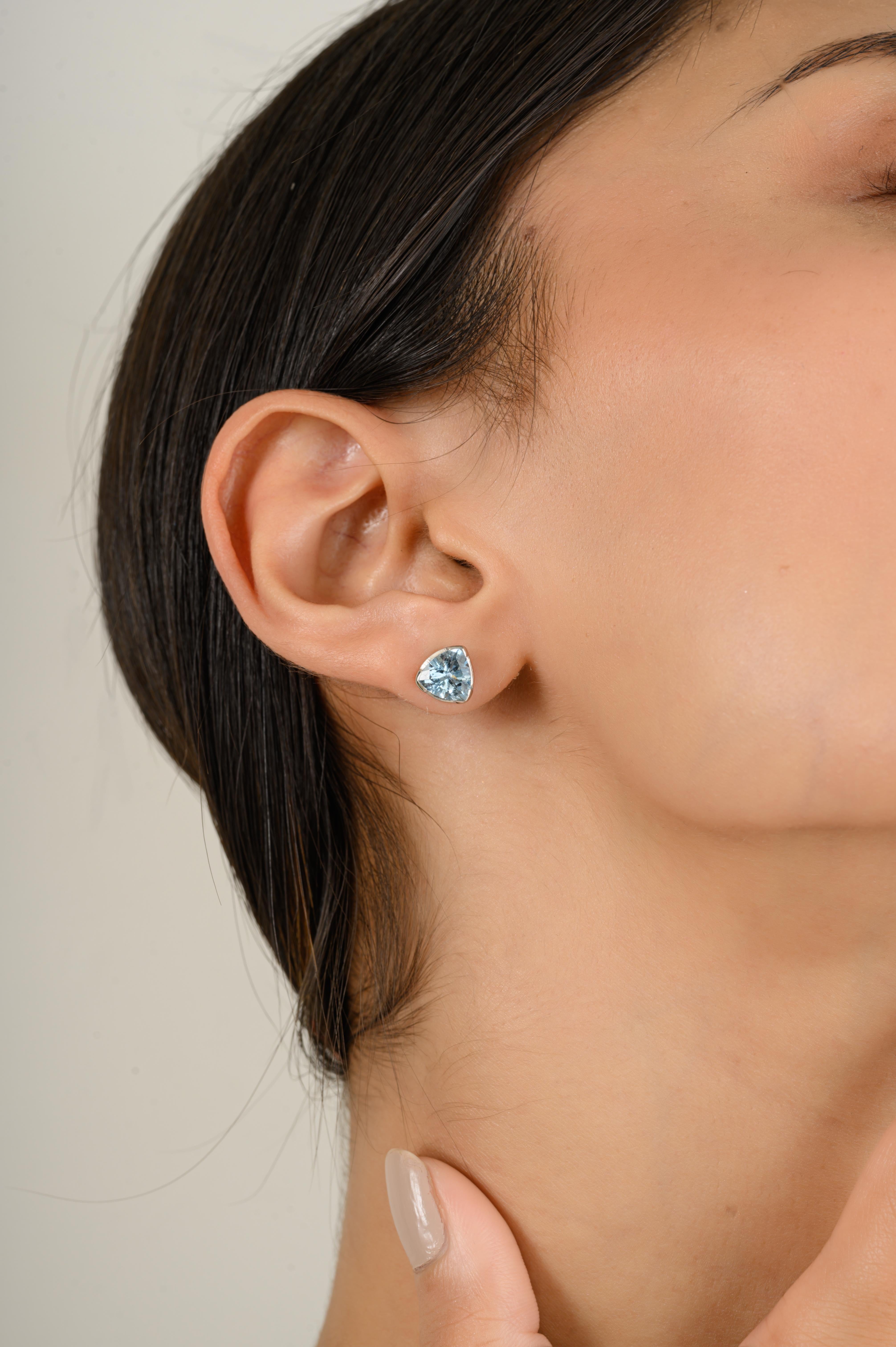 Brilliant Trillion Aquamarine Stud Earrings Gift for Her in 14K Gold to make a statement with your look. You shall need studs earrings to make a statement with your look. These earrings create a sparkling, luxurious look featuring trillion cut