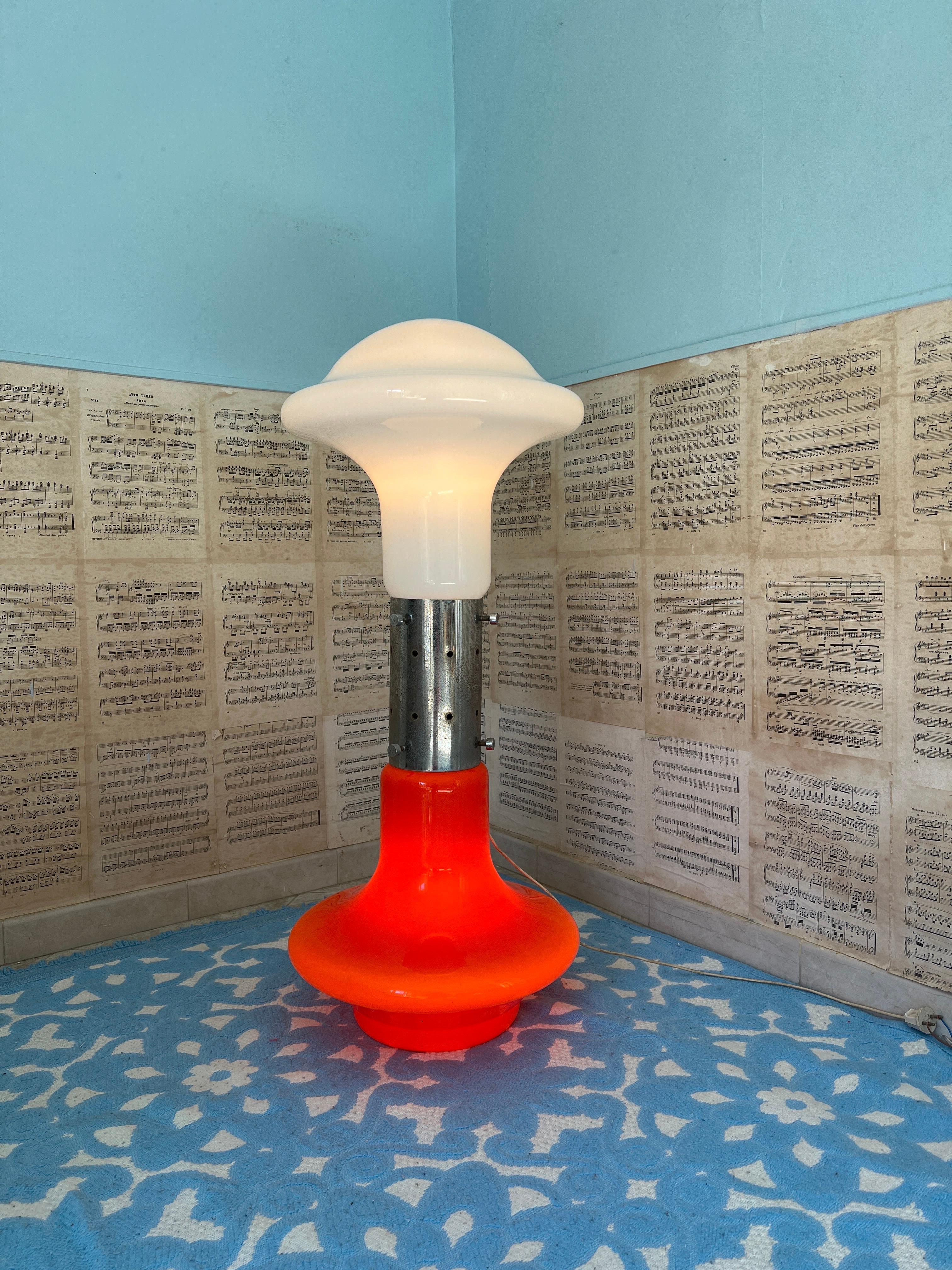 Designed by Carlo Nason for Mazzega in the 1960s, this iconic lamp is a striking example of Italian modern design. Crafted from vibrant orange and white Murano glass, it offers exceptional versatility as it can be used as both a floor lamp and a