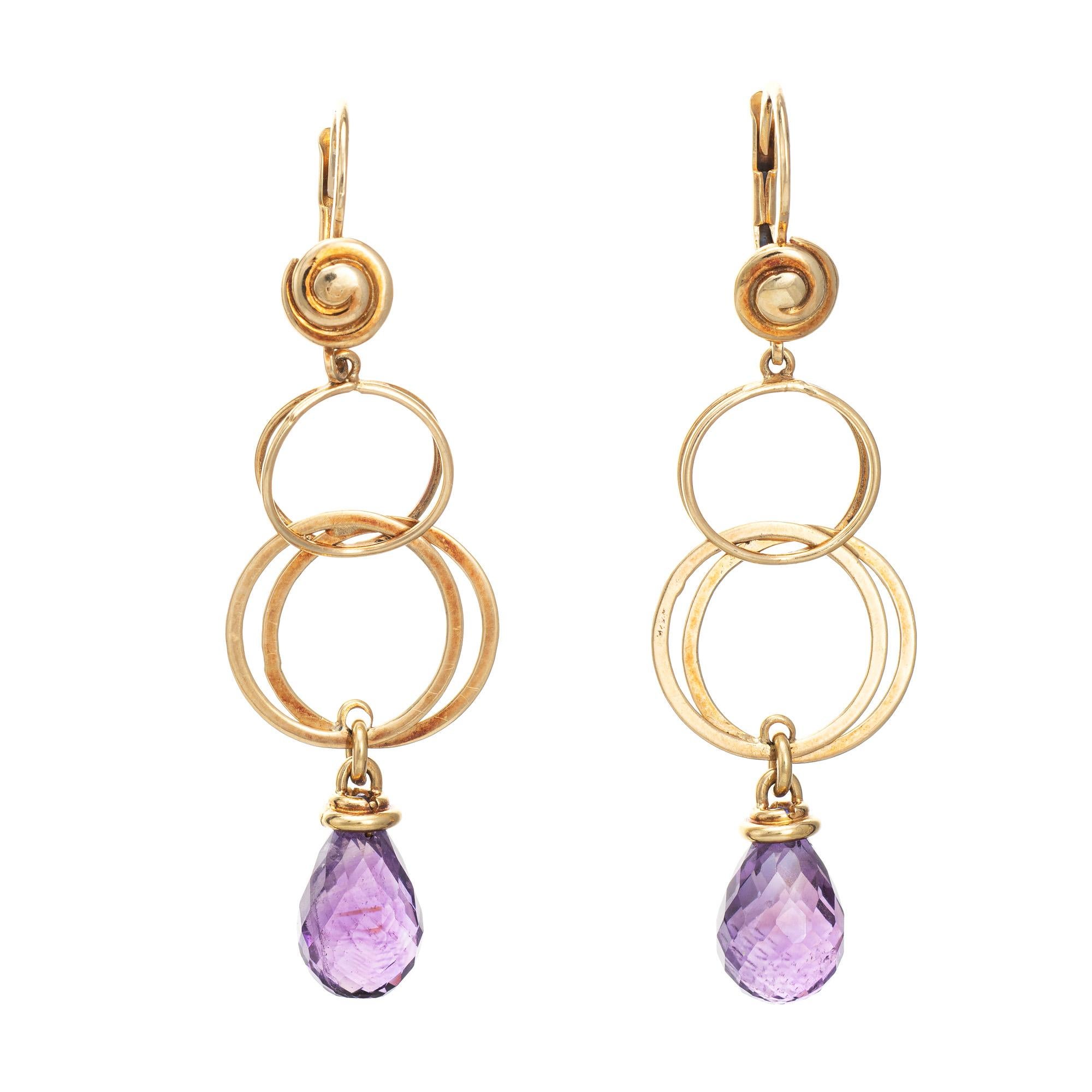 Finely detailed pair of estate briolette amethyst drop earrings crafted in 18k yellow gold. 

Briolette cut amethysts measure 10mm x 8.5mm. The amethysts are in good condition and free of cracks or chips. 
With a stylish circular design the earrings