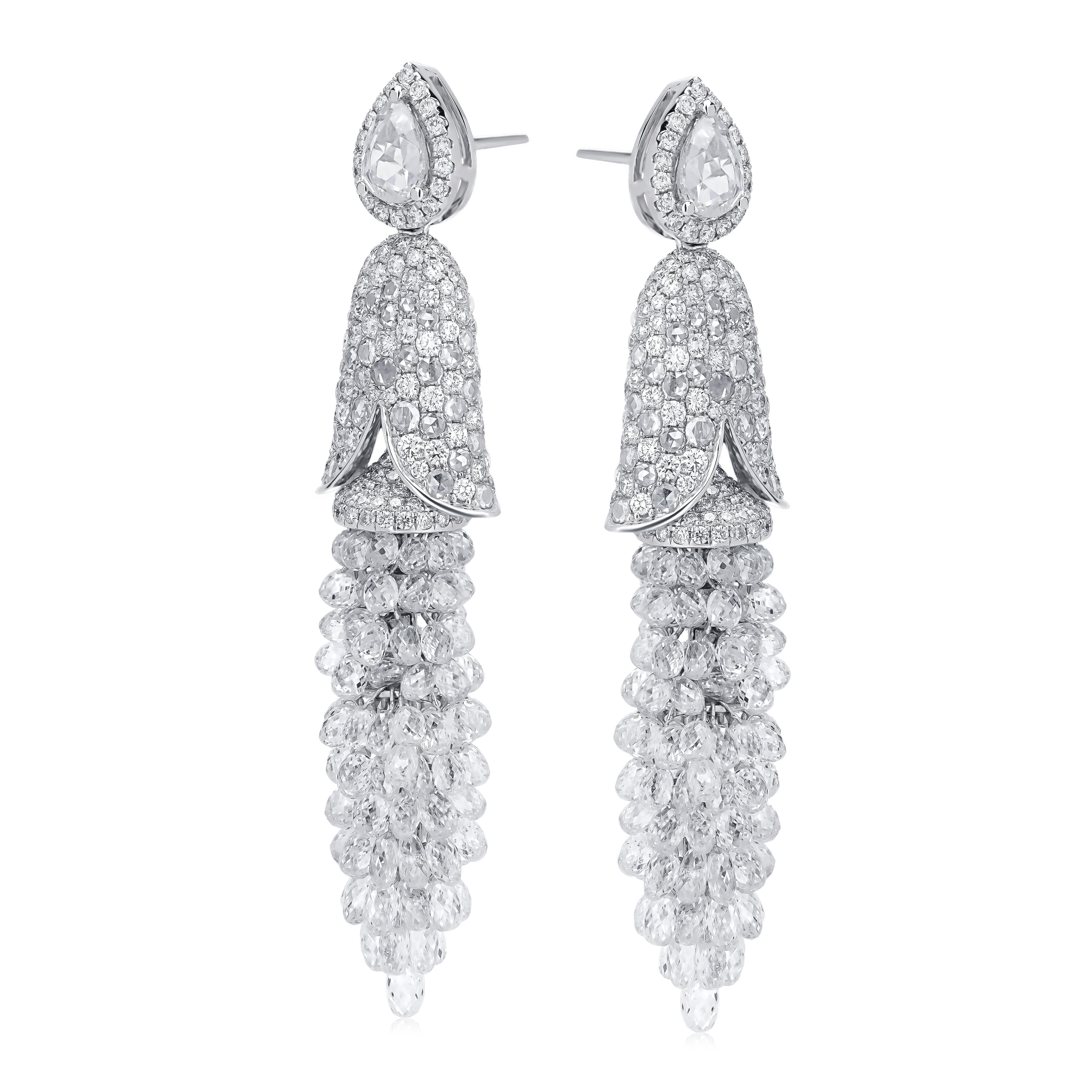 The 27.6 carat drop diamond dangle earring set in 18k white gold is a piece to behold. The surmount of this unique drop diamond earring has 0.85 rose cut pear diamonds surrounded by a halo of round full cut pave diamonds. The intricate design of the