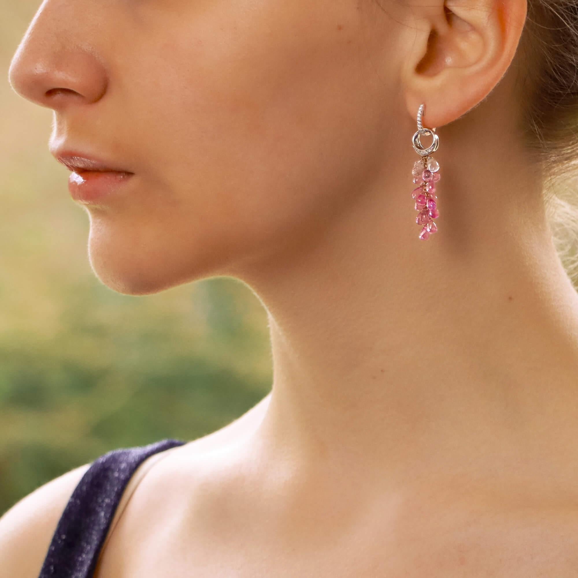A lovely pair of diamond and briolette sapphire convertible drop earrings set in 18k white and rose gold.

Each earring has been beautifully crafted and firstly features a petite pavé set diamond hoop. From this hoop suspends an openwork circular