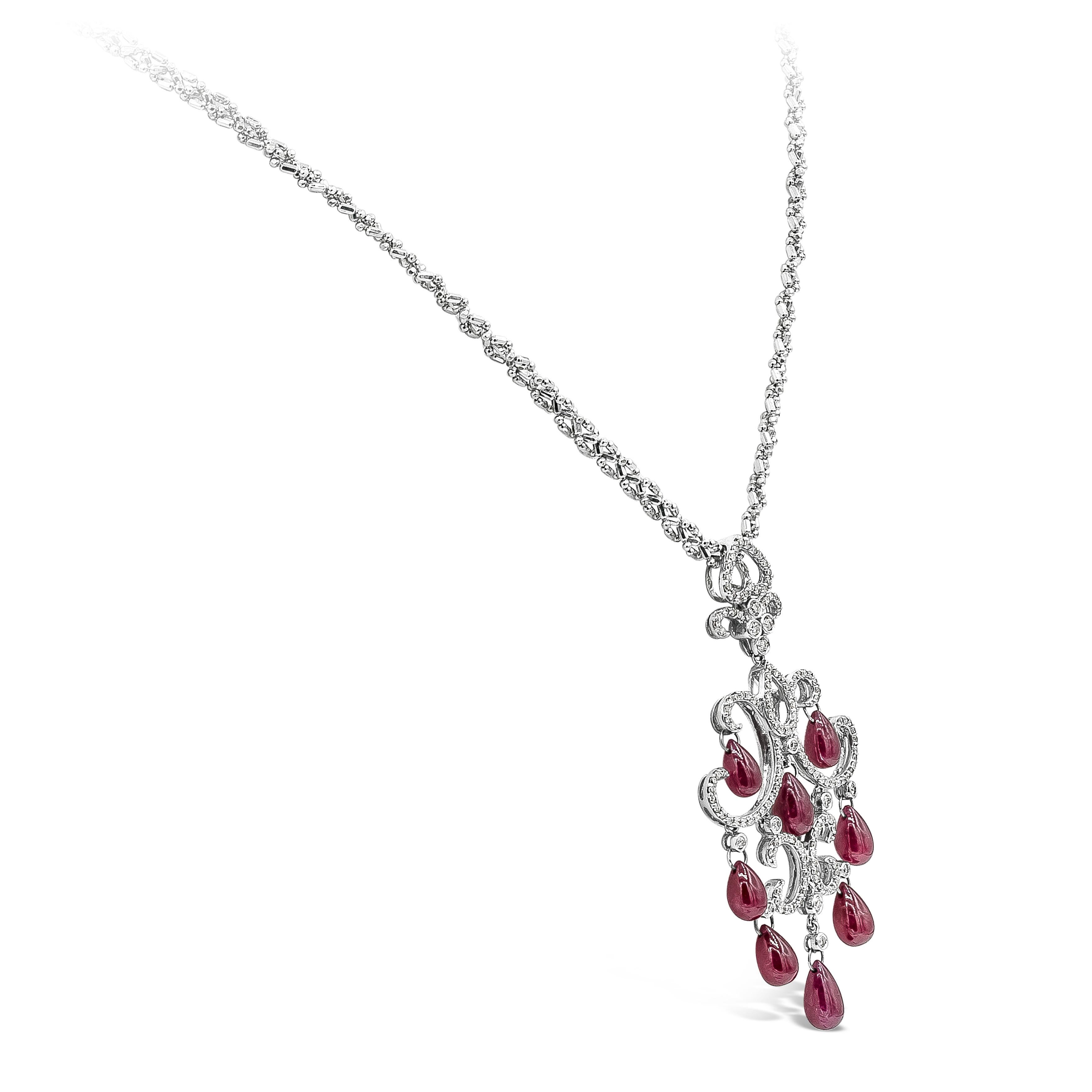 An intricately designed piece encrusted with round brilliant diamonds weighing 0.80 carats total. Finished with color-rich ruby briolettes weighing 16.25 carats total. Pendant length of 2.5 inches and chain length of 19 inches.
