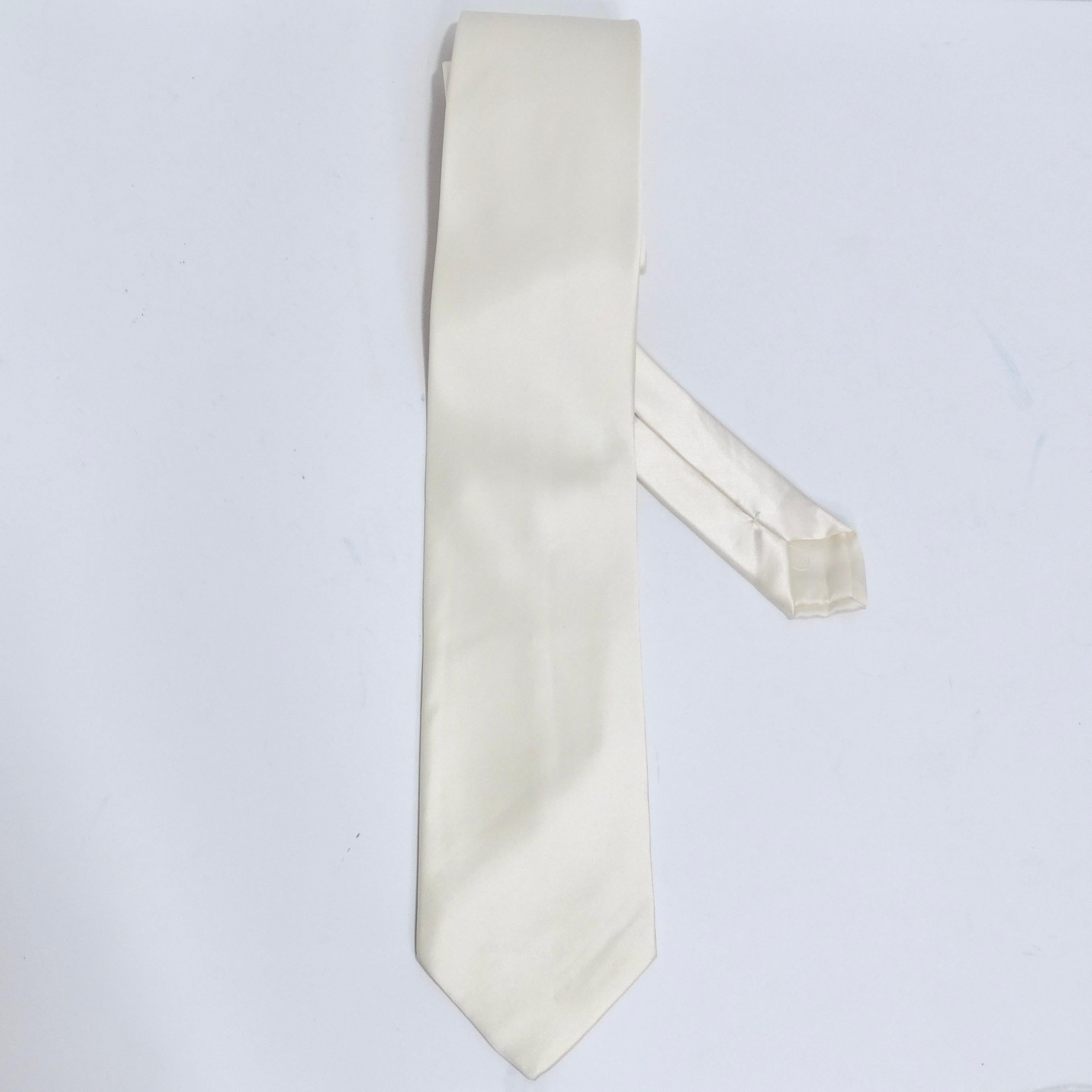 Introducing a true classic: the Brioni 1990s Ivory Silk Tie. This timeless piece exudes sophistication and versatility. Crafted from luxurious ivory silk, it's the perfect accessory to elevate your style. Brand new with tags, this tie is a testament