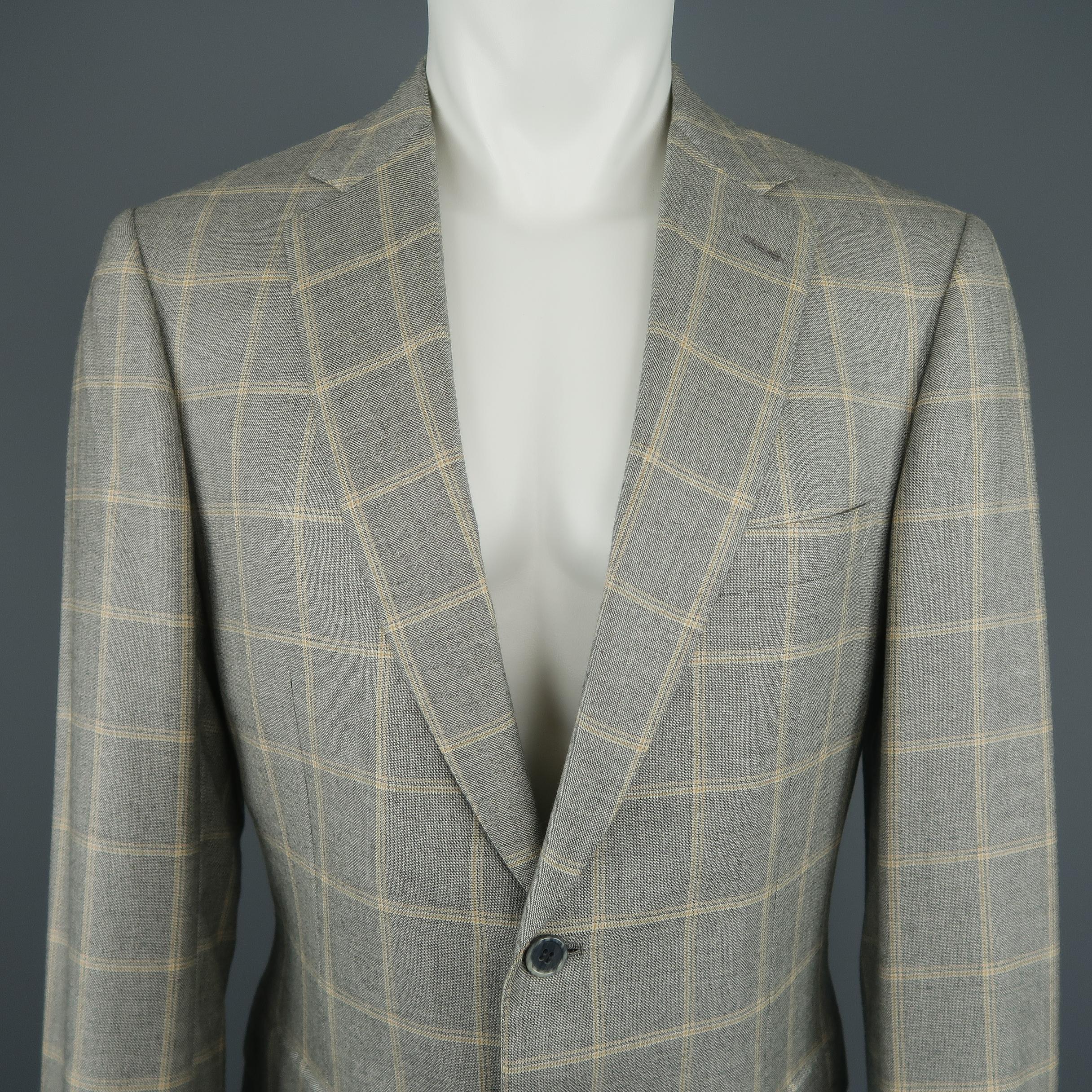 BRIONI sport coat comes in silk wool blend light gray and gold windowpane fabric with a single breasted two button closure, notch lapel, and functional button cuffs. Made in Italy.
 
Excellent Pre-Owned Condition.
Marked: 40R
 
Measurements:
